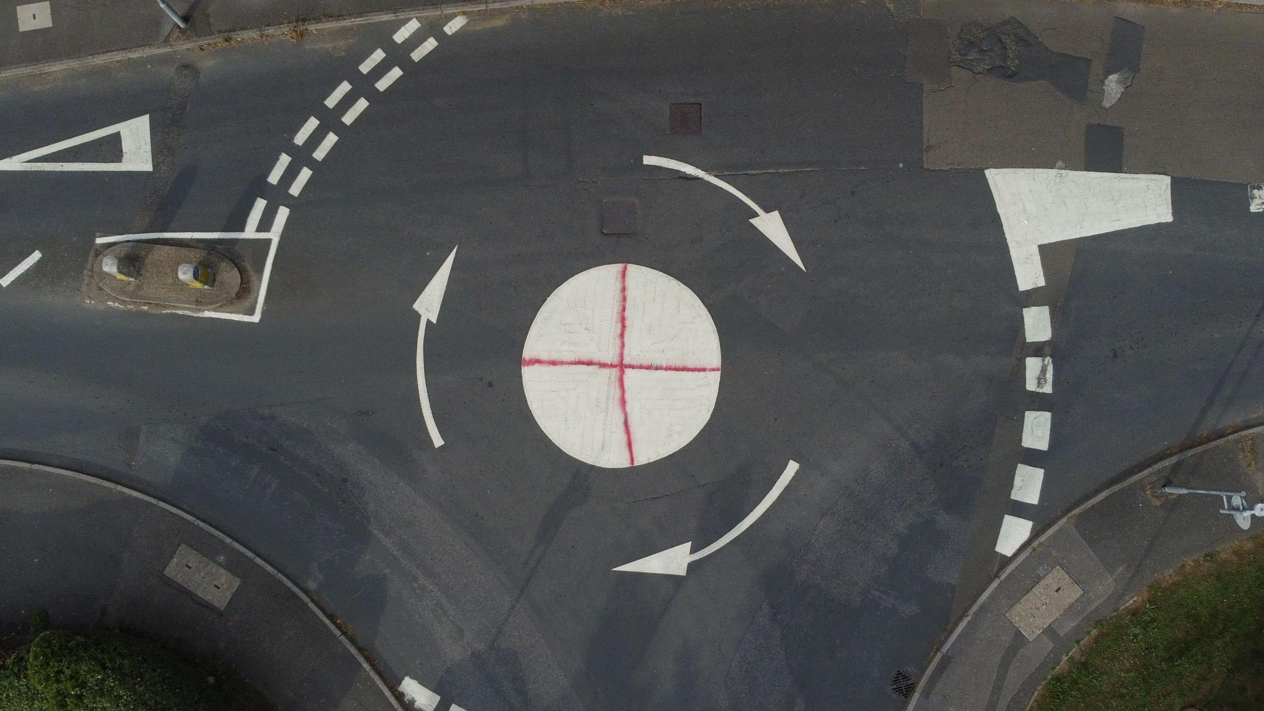 A St George's Cross spray painted on a roundabout.