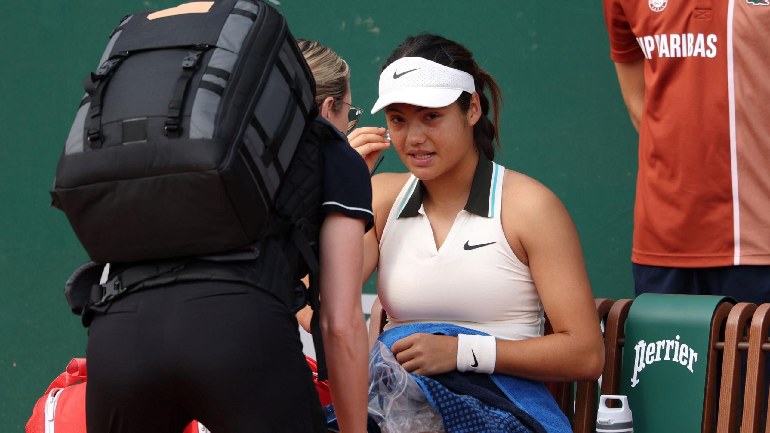 Emma Raducanu receives treatment