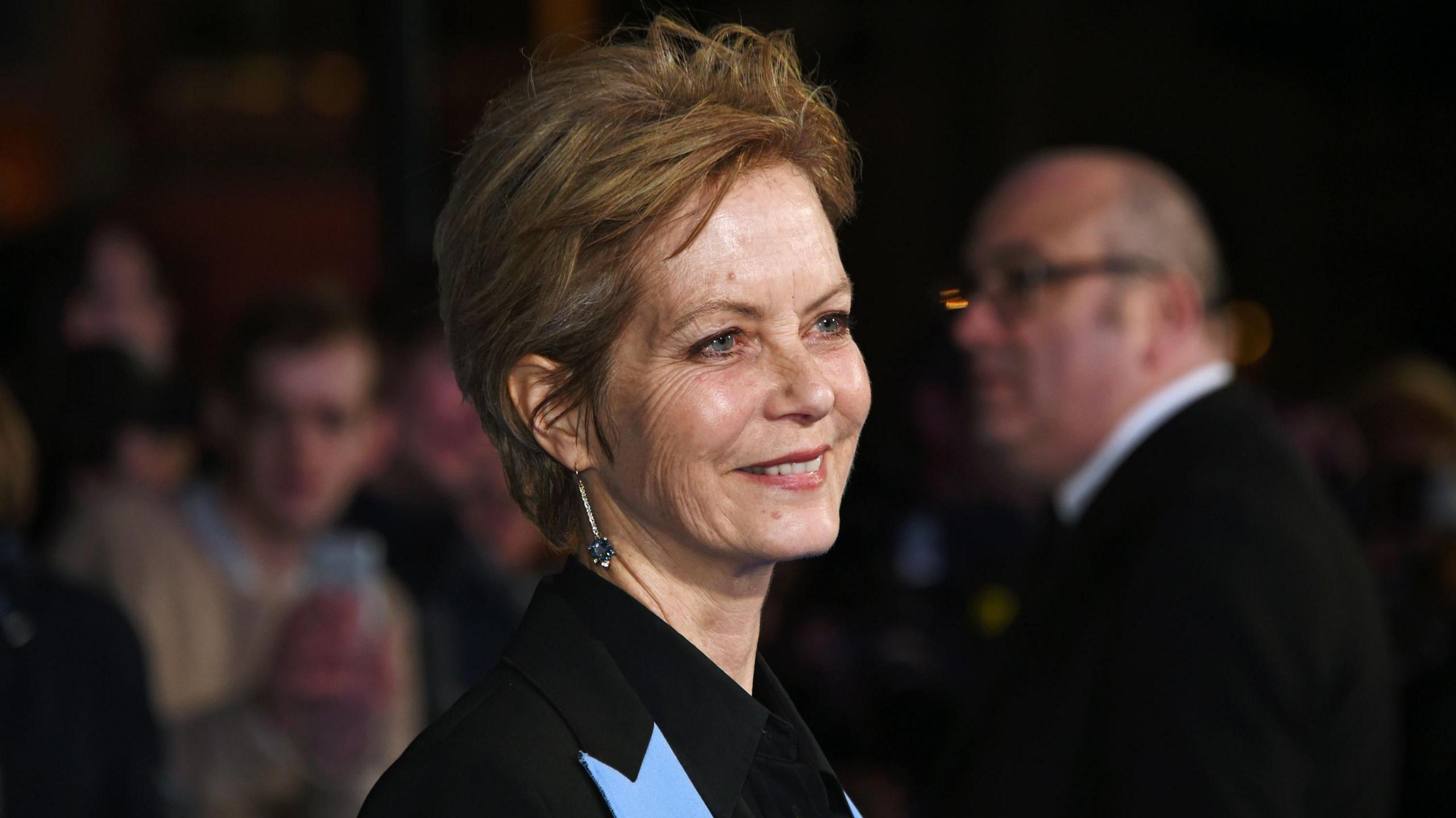 Jenny Seagrove at a film premier, wearing a dark jacket with light blue lapels.