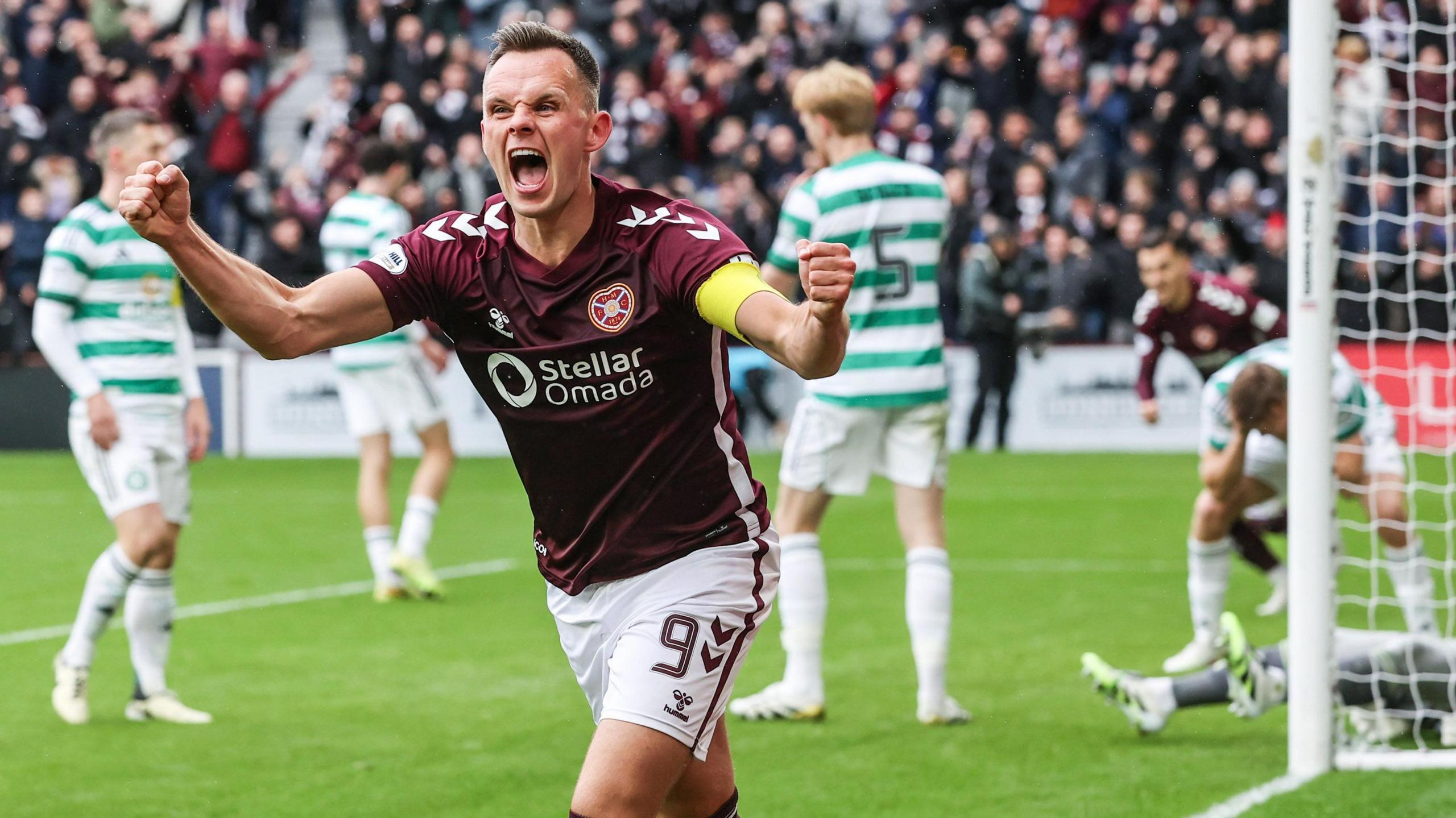 Lawrence Shankland celebrates after scoring a penalty for Hearts against Celtic