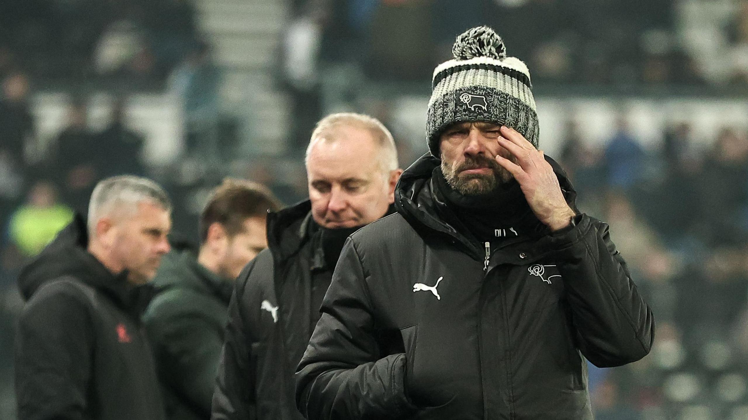 Derby boss Paul Warne with a grimace on his face as he walks off the pitch at Pride Park