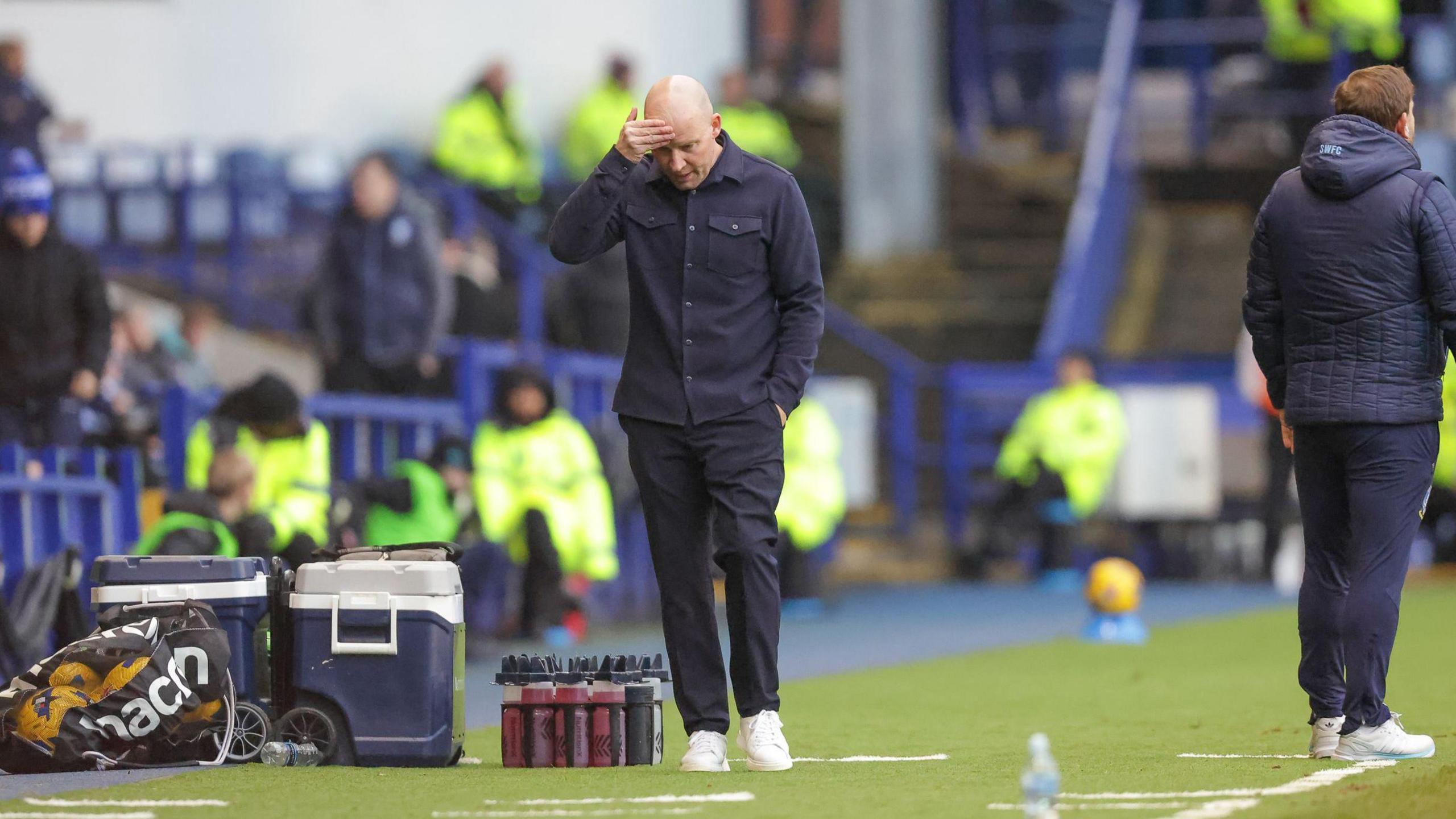 Henrik Pedersen scratches his head on the Sheffield Wednesday sideline