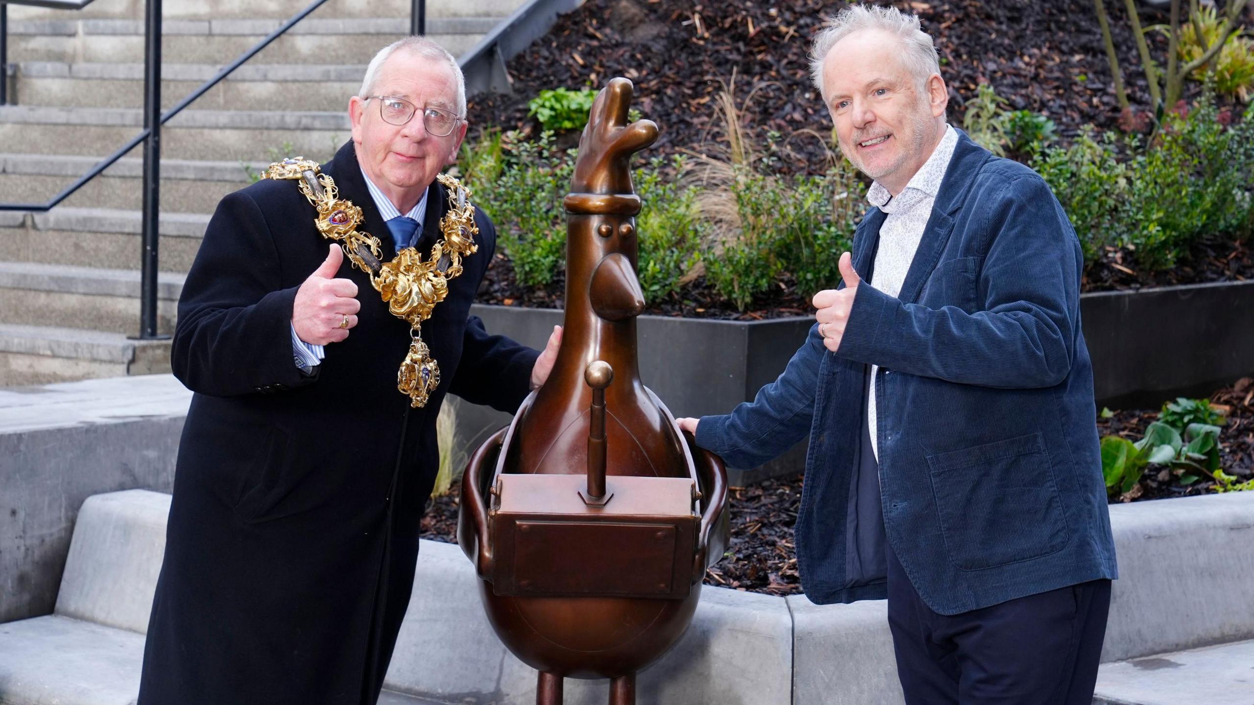 Wallace and Gromit creator Nick Park and the Mayor of Preston, Councillor Phil Crowe, pose next to the statue of the animated character Feathers McGraw