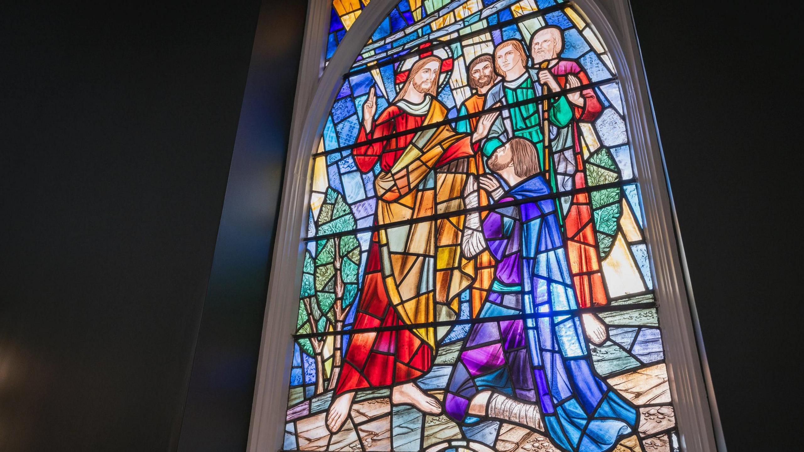 A close-up of a stained glass window in what is now a meeting room.