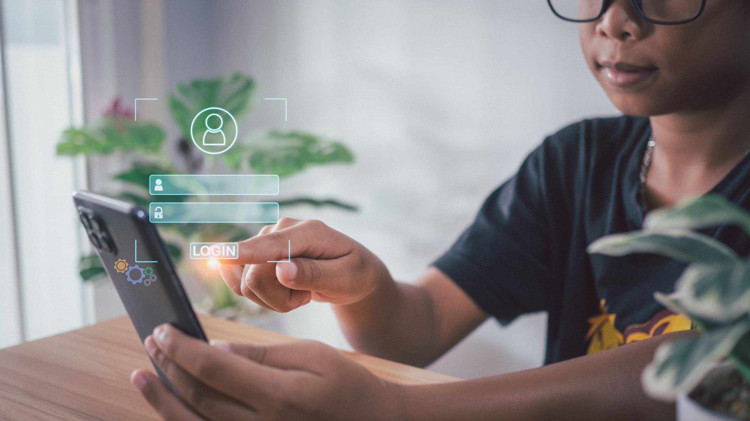Child is pressing on a phone and a login window has appeared