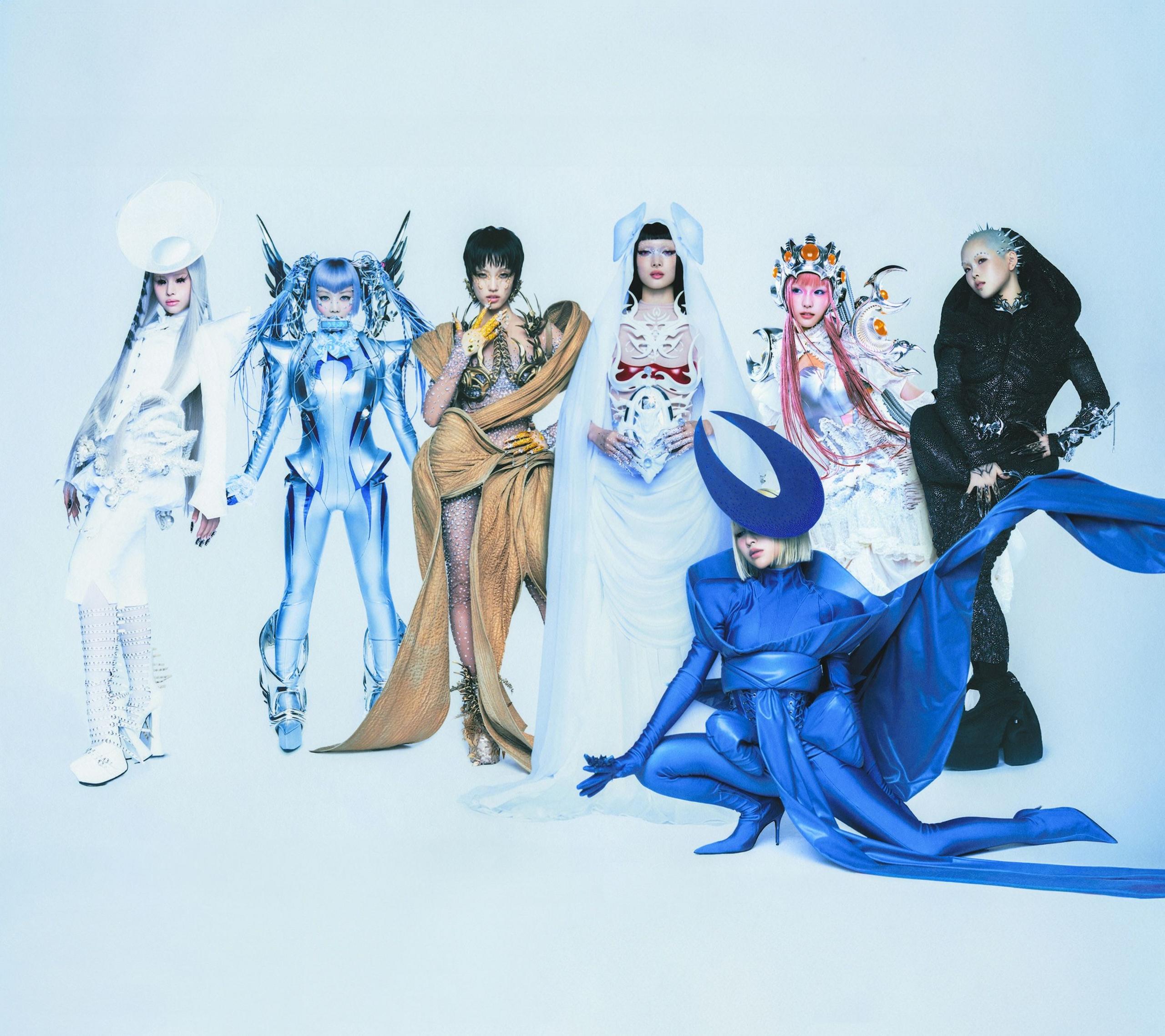 The seven members of XG pose in a series of futuristic, semi-alien outfits in a promotional image for their album, The Core