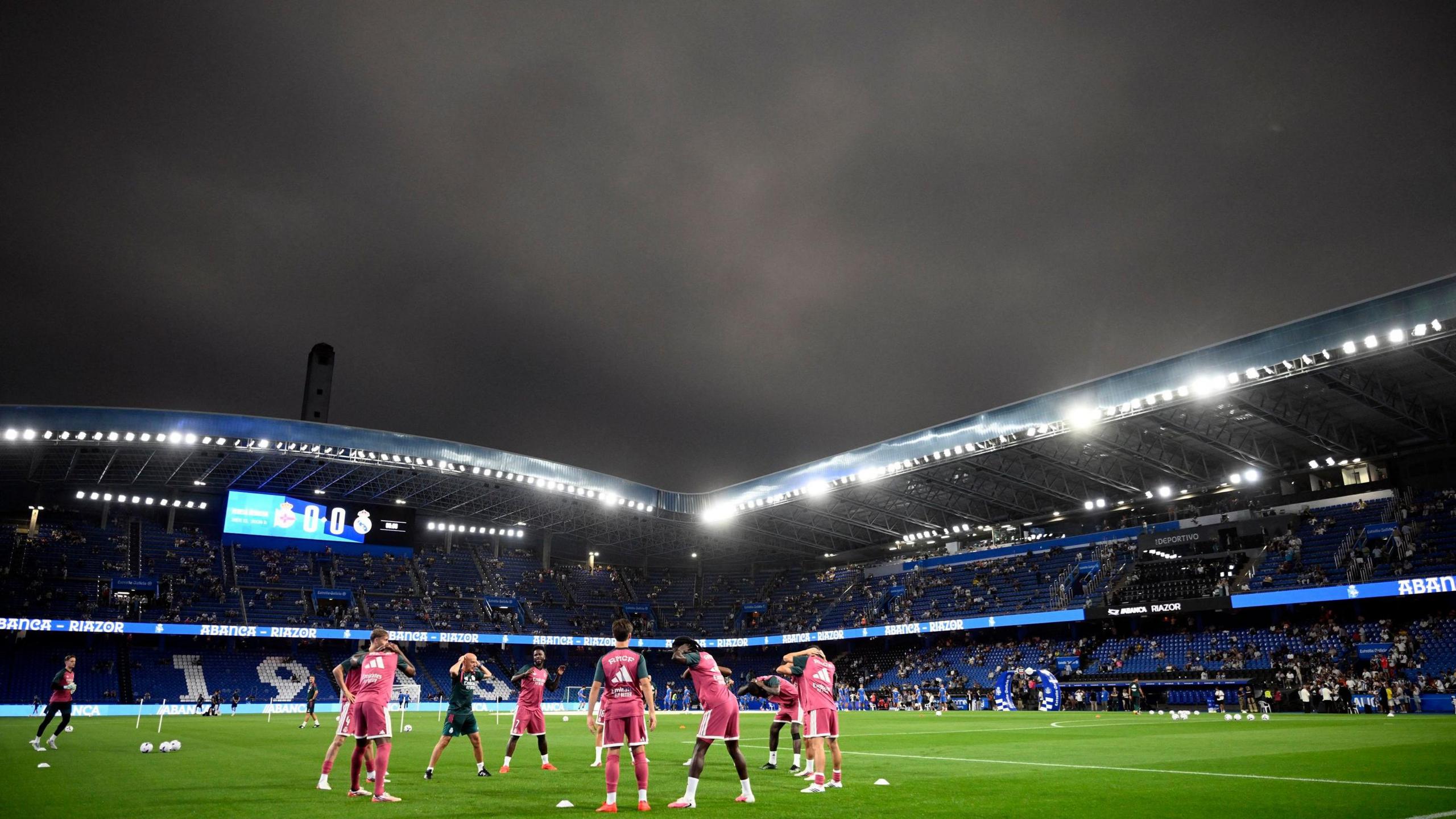 Real Madrid players warm-up at Deportivo La Coruna's stadium during the solar eclipse