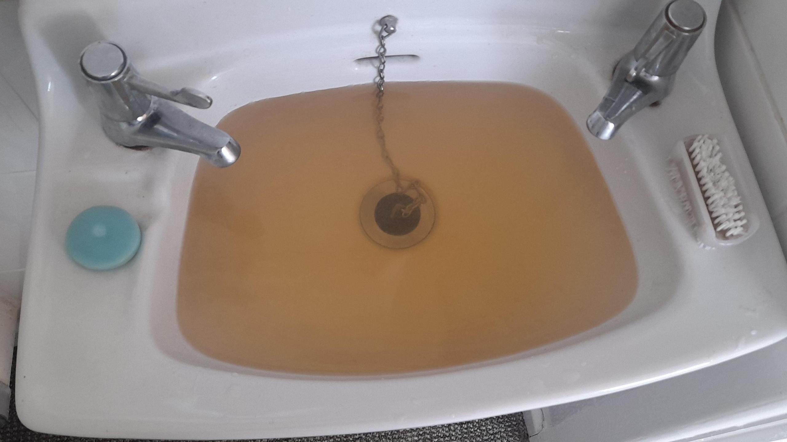 Sink full of discoloured water