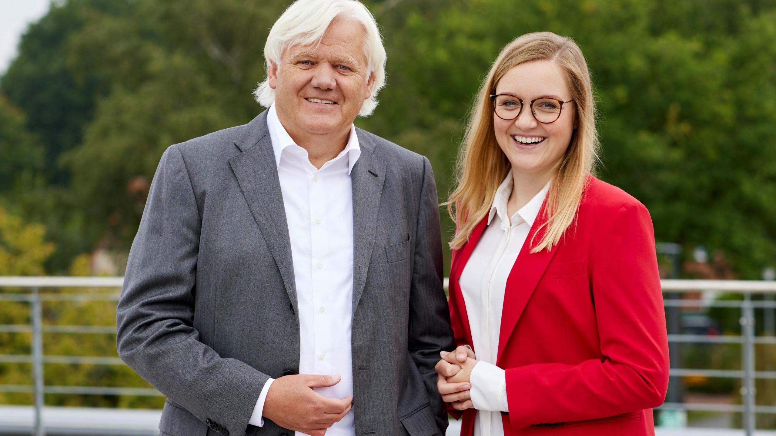 German business owner Hans Beckhoff and his daughter Frederike, who helps to run their family-owned company, smile at the camera.