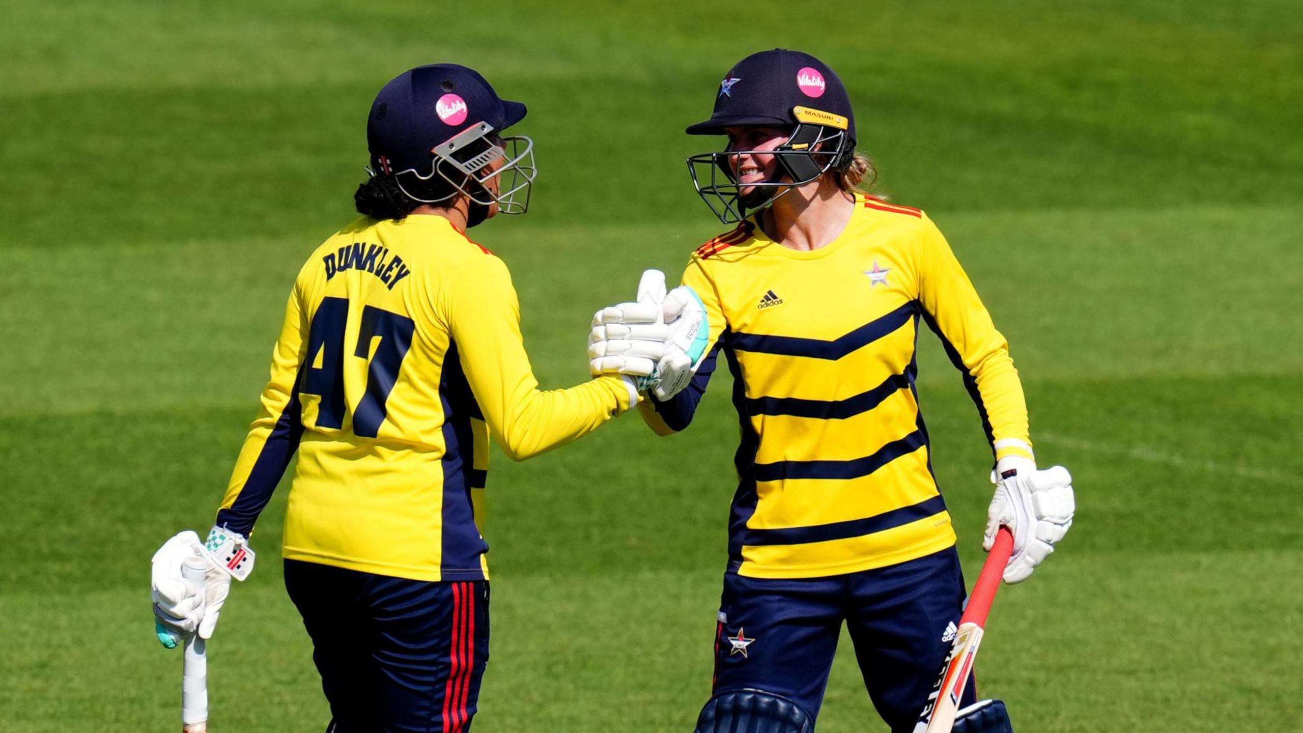 Paige Scholfield (right) celebrates reaching her half-century against Southern Vipers with Sophia Dunkley