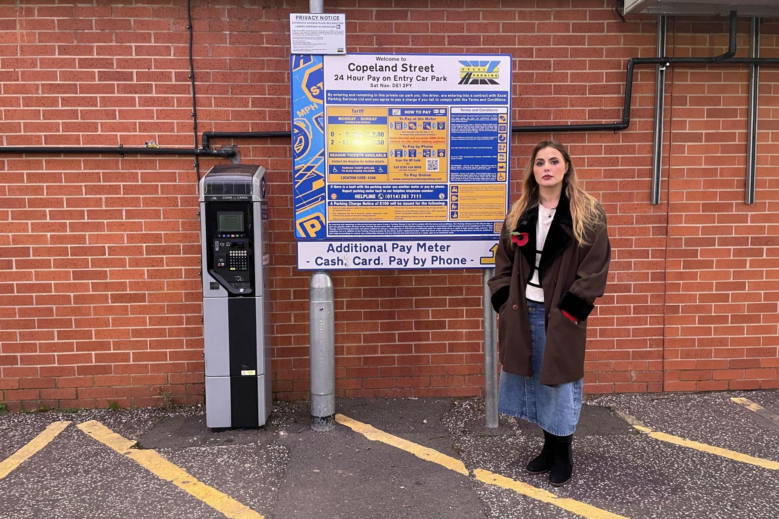 Rosey Hudson standing by a car park paying machine in Copeland Street, Derby