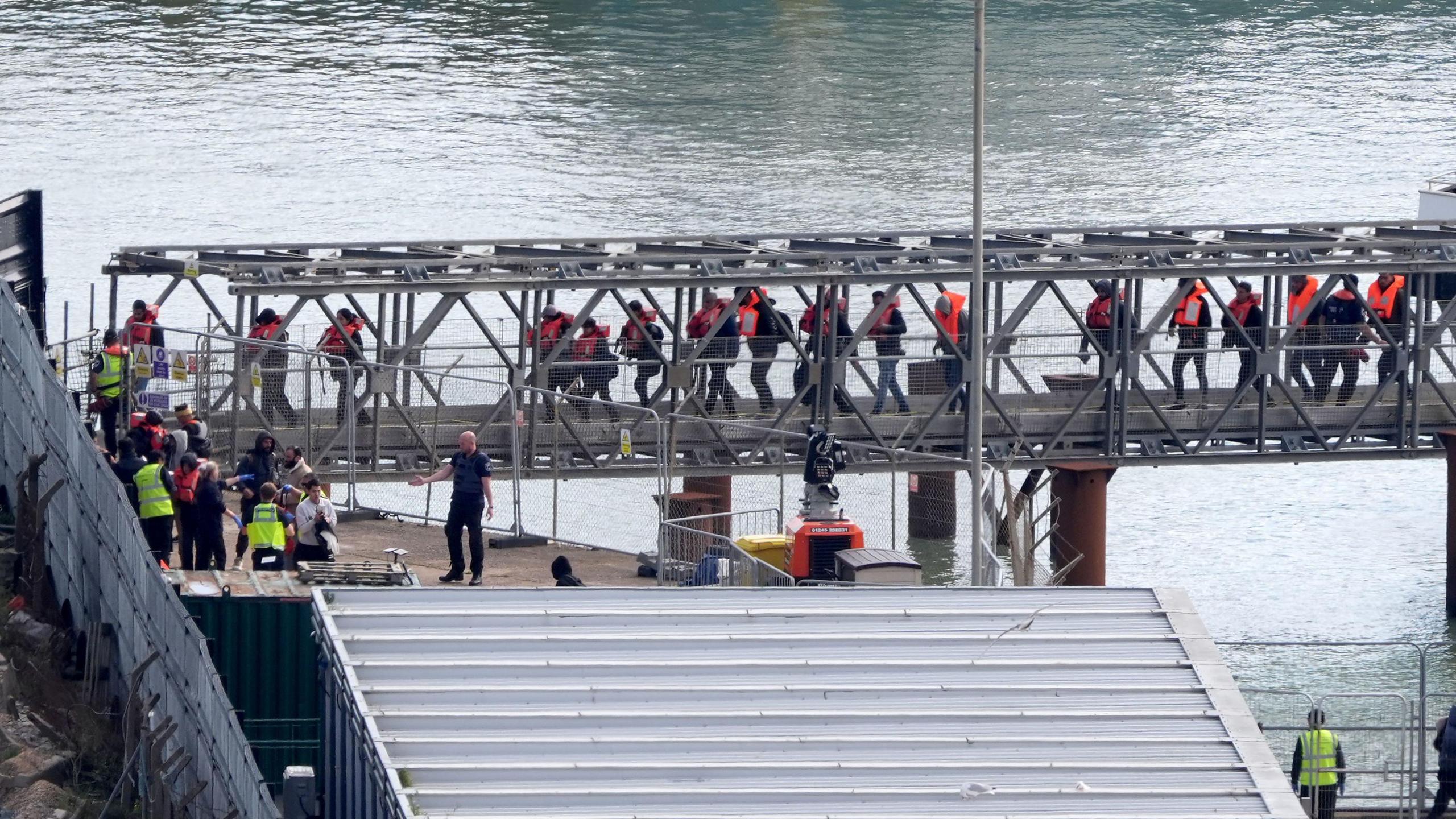 A group of people brought in to Dover, Kent, from a Border Force vessel on Friday