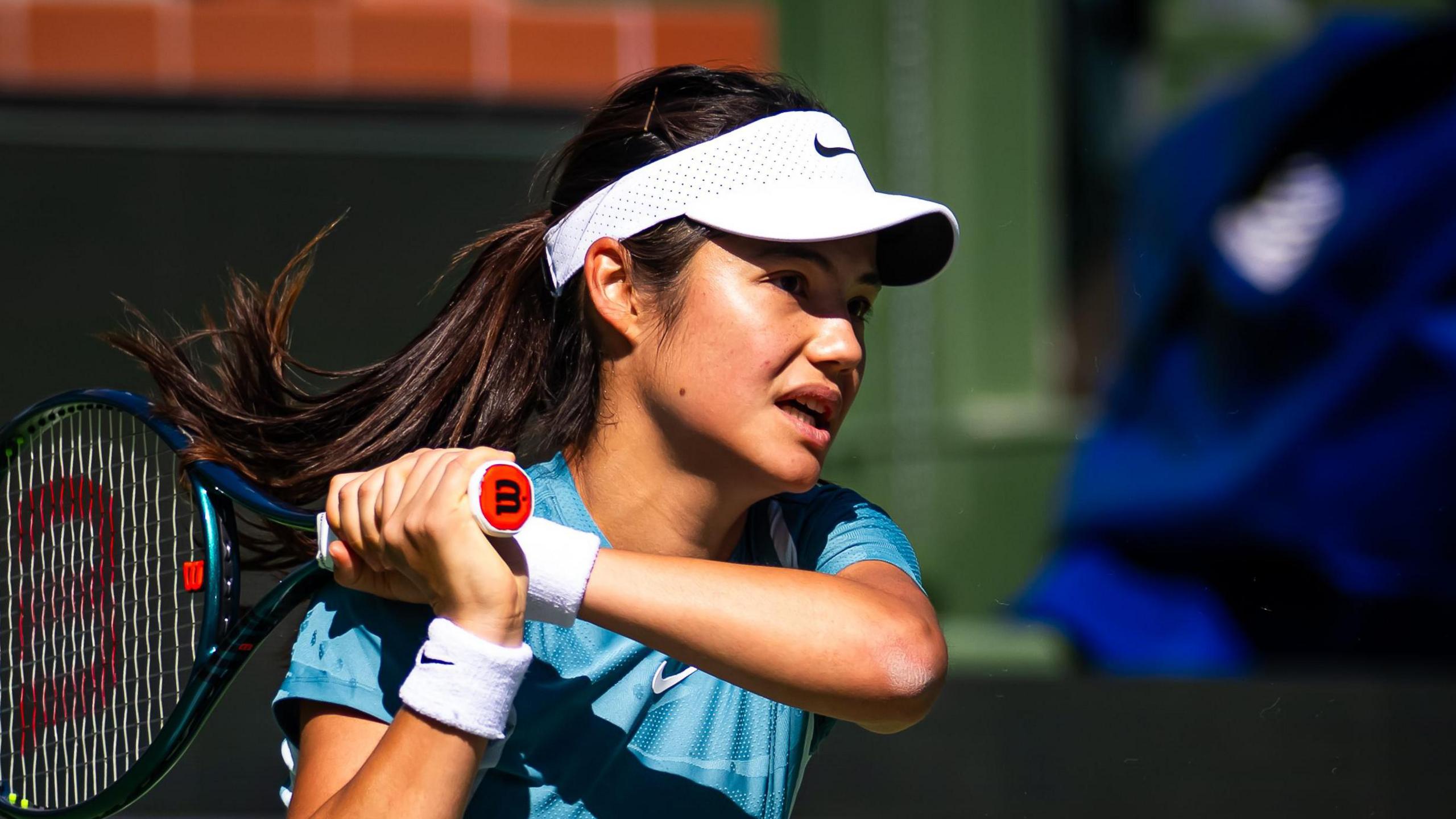 Emma Raducanu hits a return during practice in Indian Wells