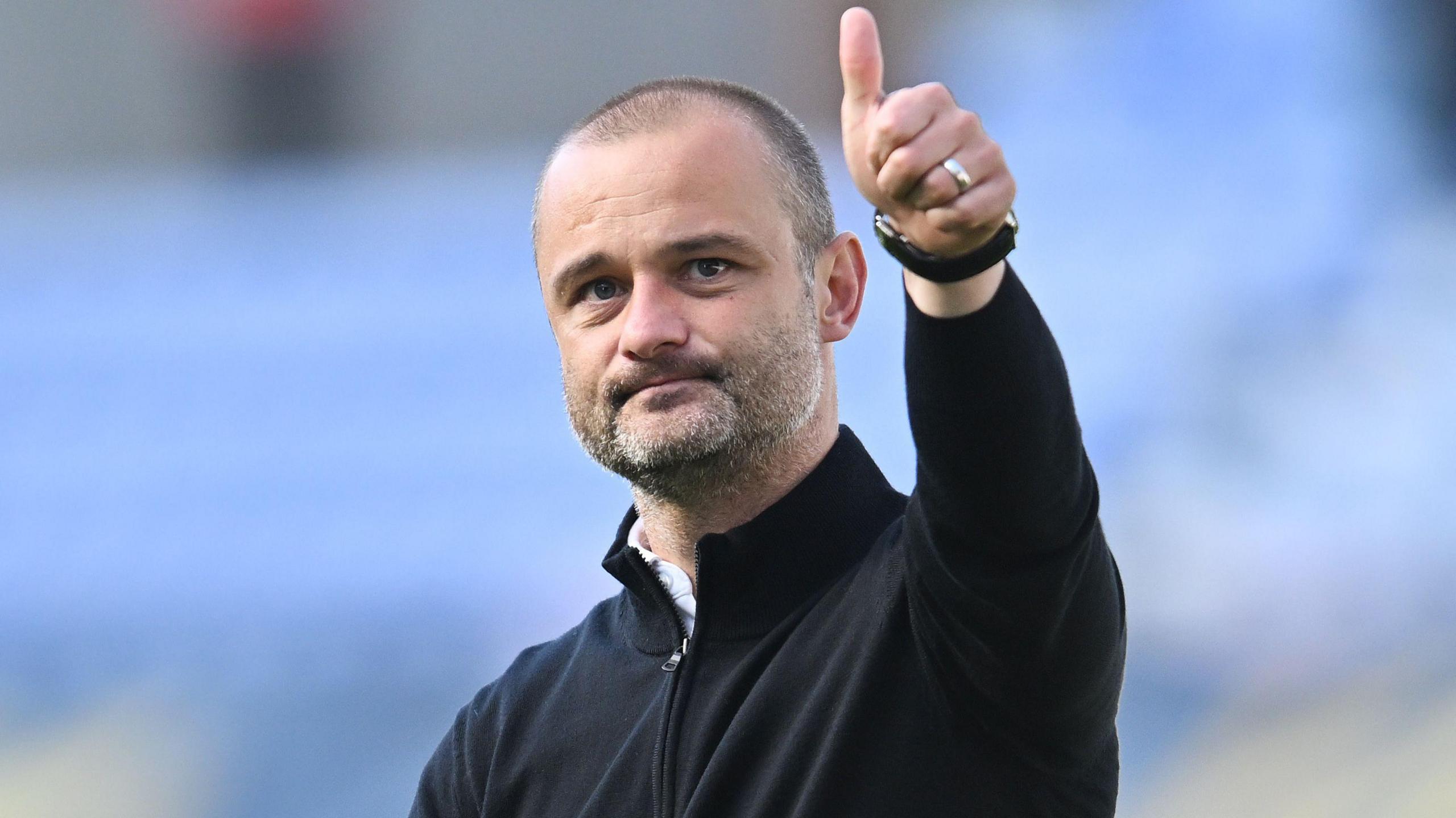 Wigan boss Shaun Maloney gives a thumbs up to their fans