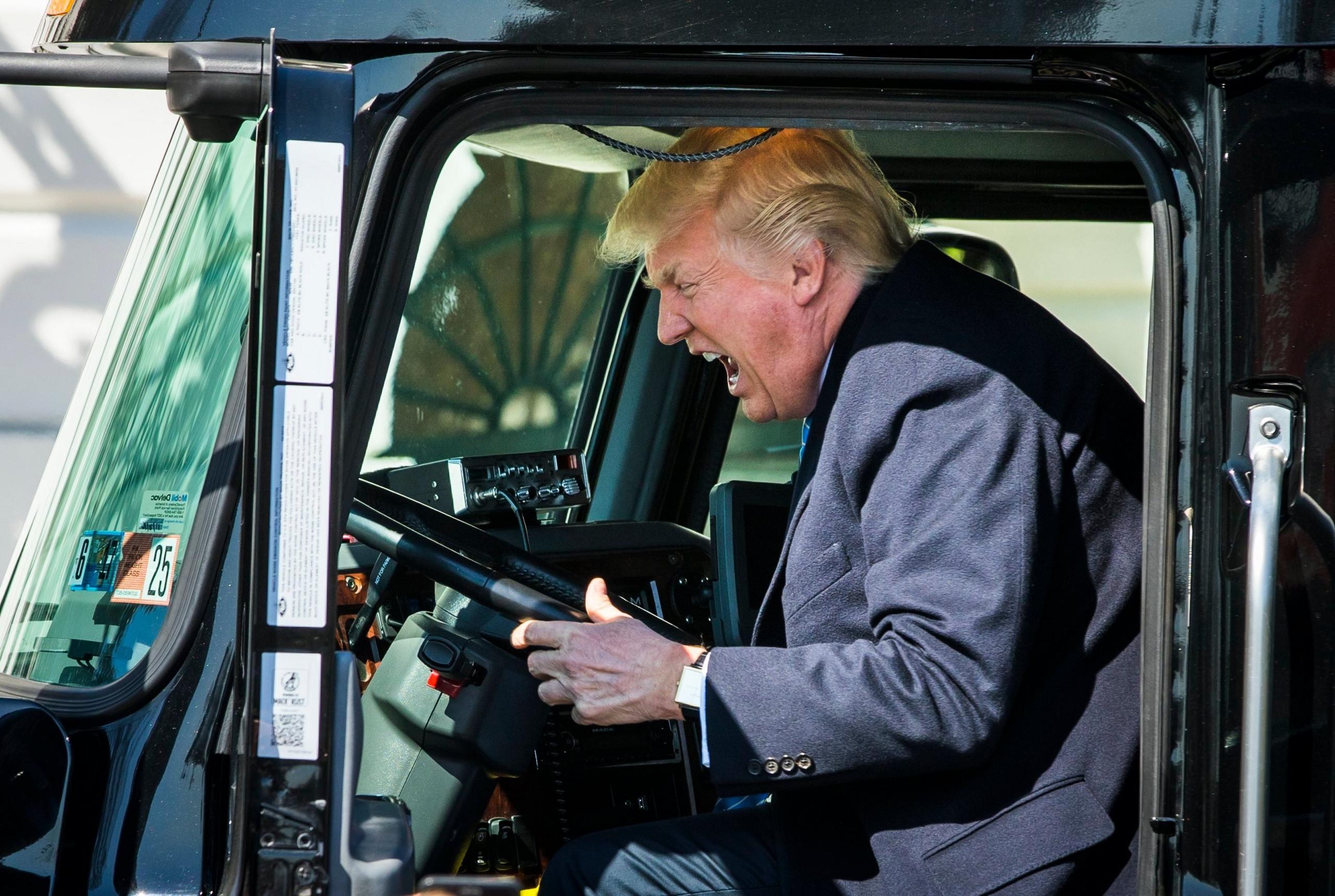 Donald Trump gets in the driver"s seat of an 18-wheeler while meeting with truck drivers and trucking CEOs prior to their meeting to discuss health care at the White House in Washington, DC on 23 March 2017