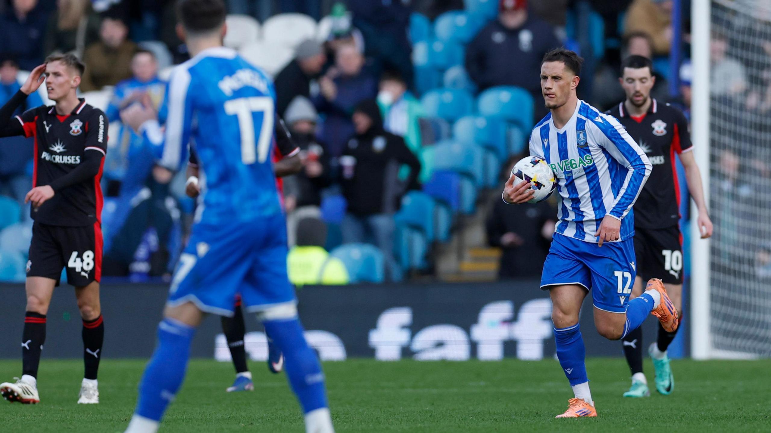 Jerry Yates returns to the centre circle with ball in hand after scoring