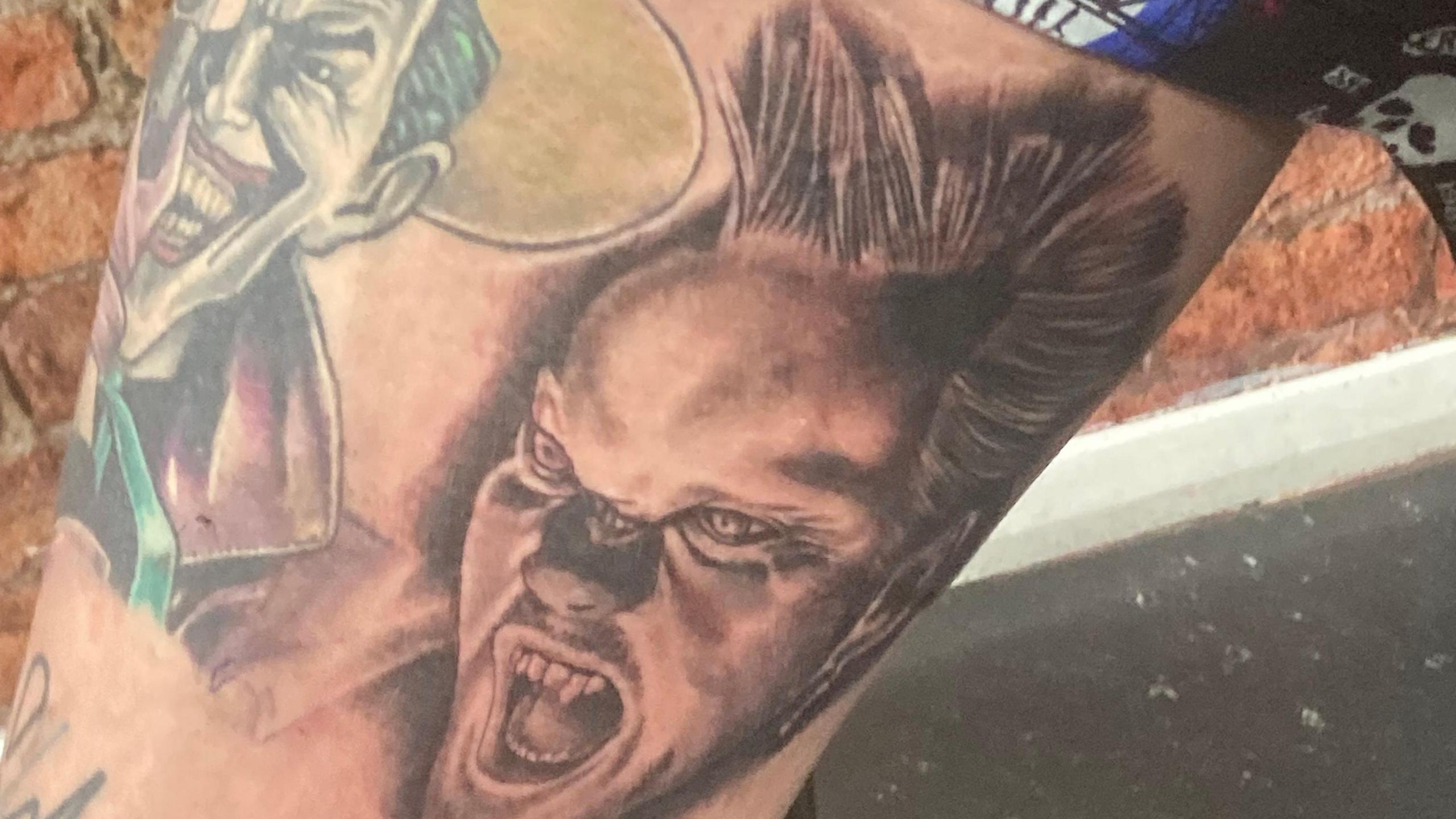 Annie's leg showing the finished tattoo. It shows the head of Kiefer Sutherland playing a vampire next to a tattoo of The Joker.