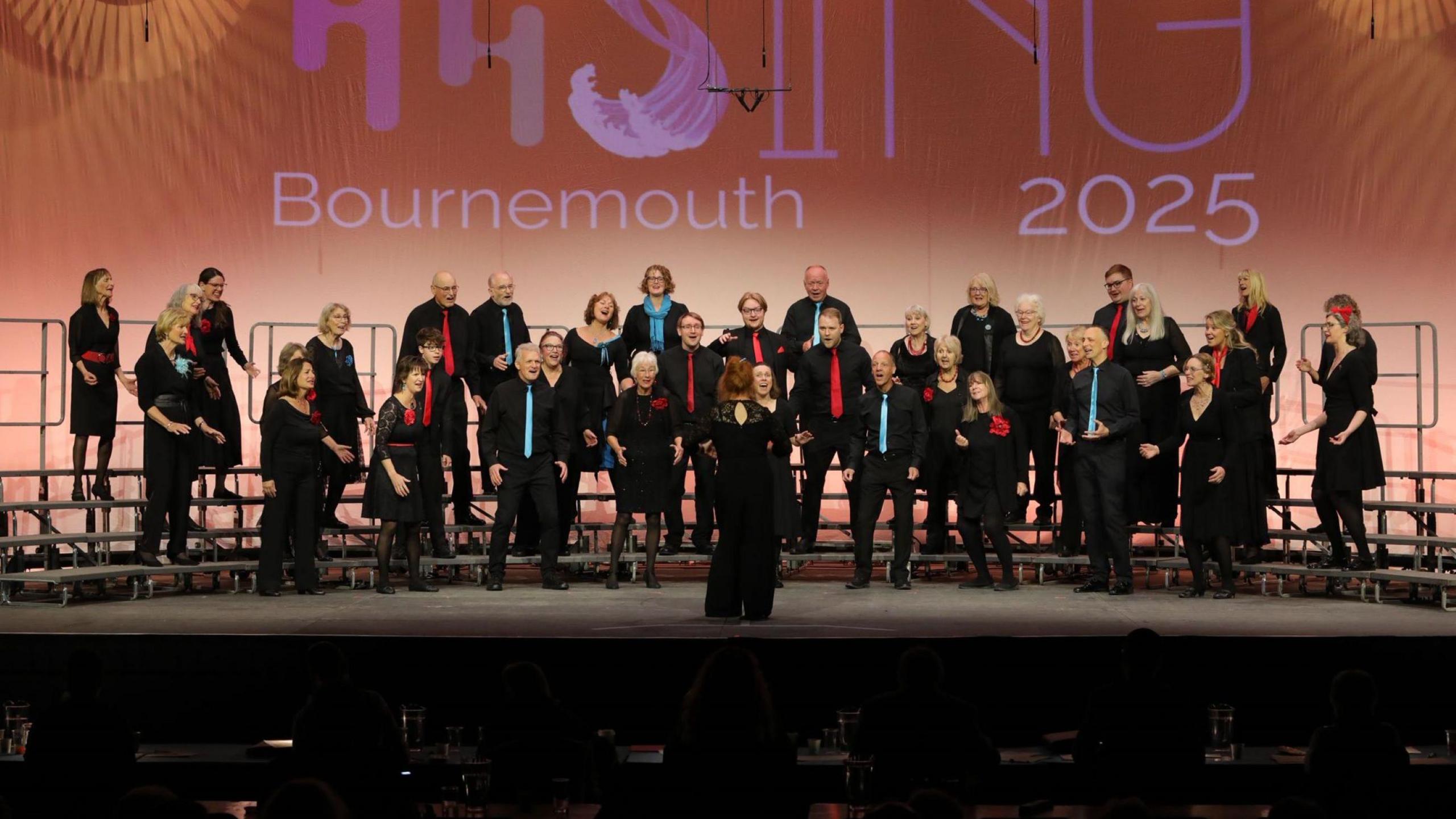 Members of the Bristol Mix choir perform on stage at the BABS awards in Bournemouth. They are a mixed choir of men and women and are largely dressed in black