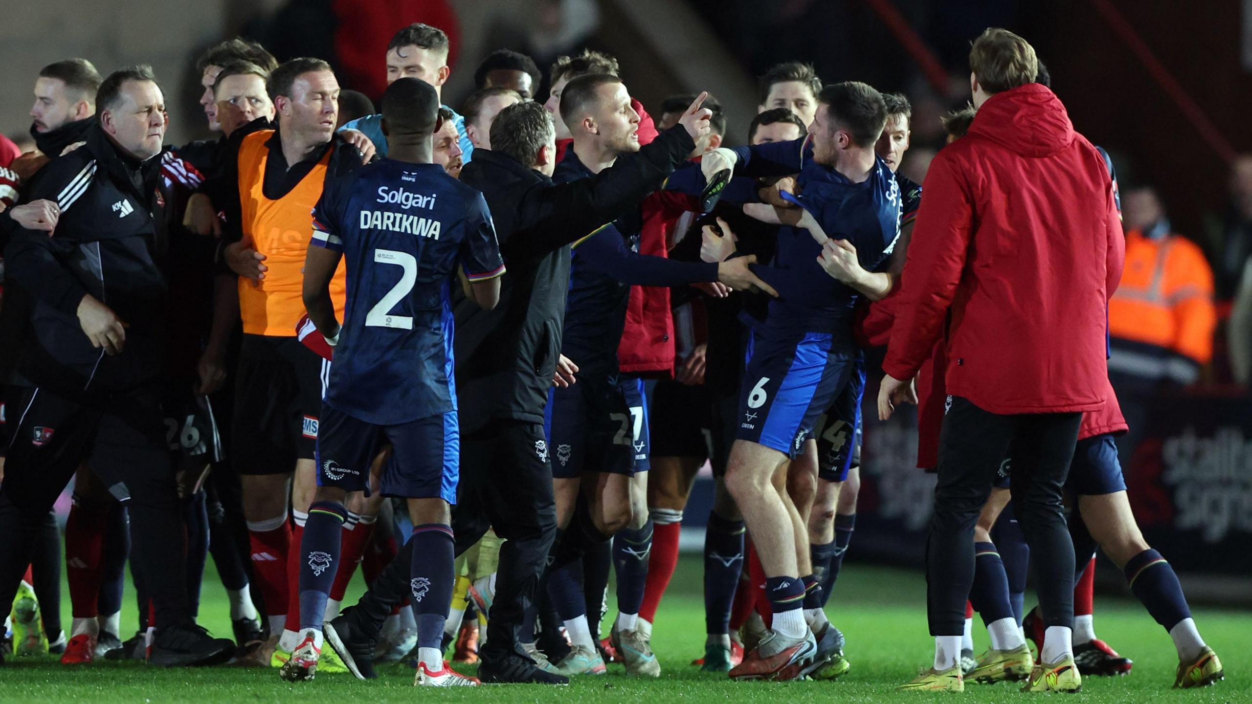 A group of Lincoln City and Exeter City players clash after the Imps' win at St James Park on Tuesday 