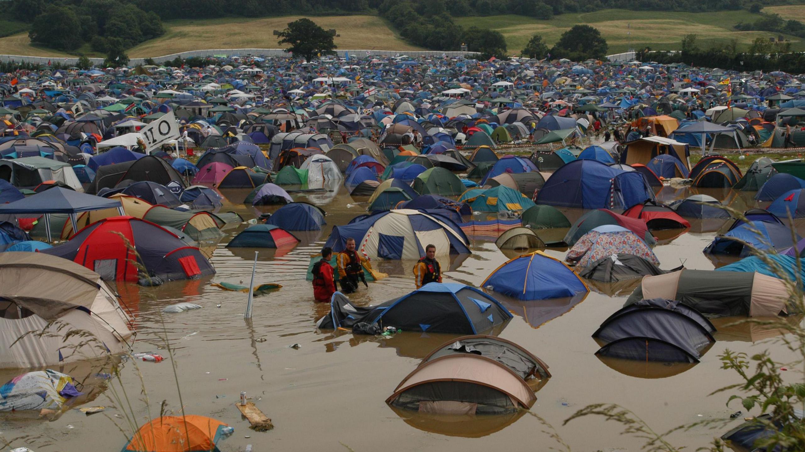 A field full of tents at Glastonbury submerged by floodwaters
