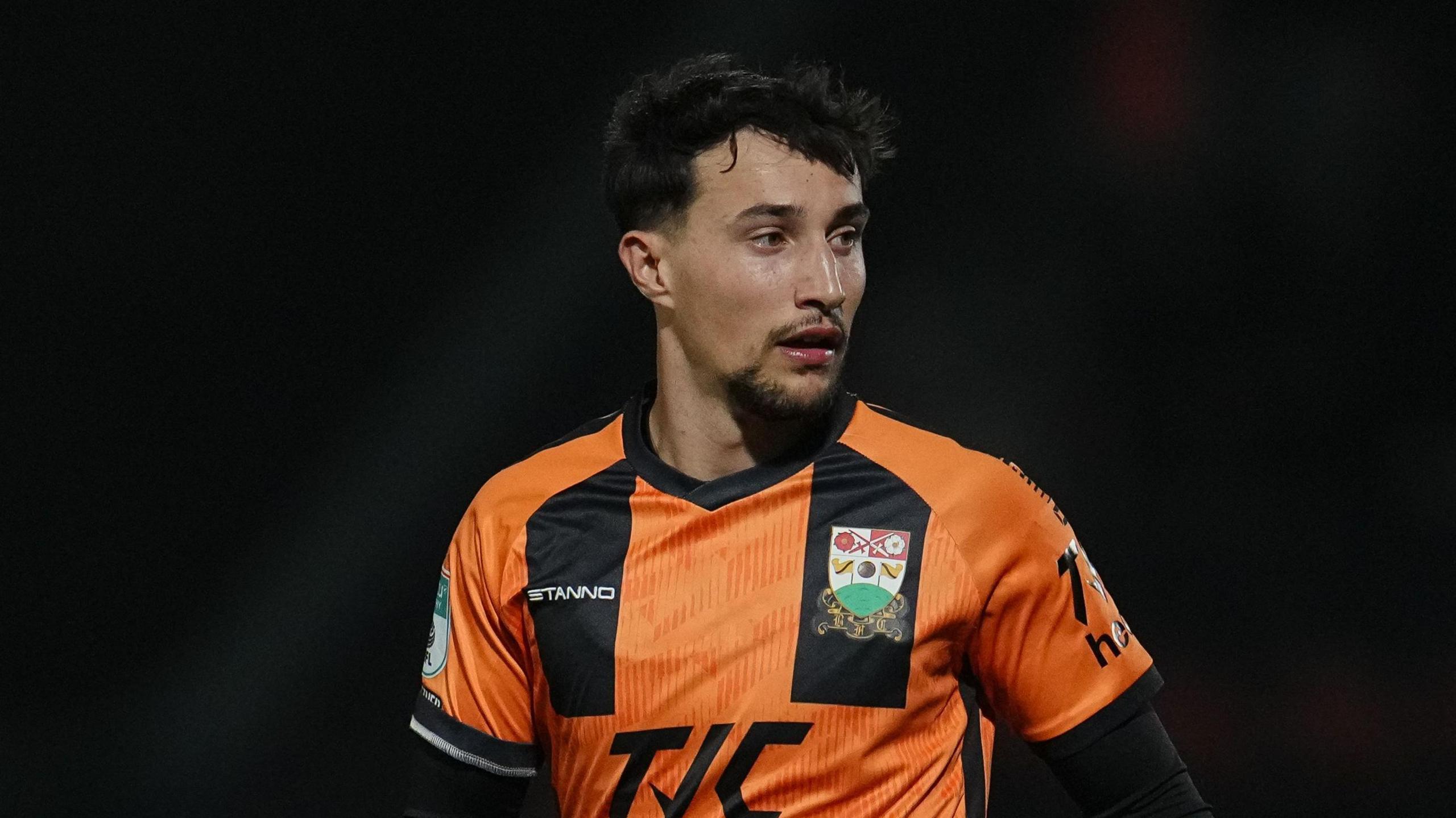 Ryan Galvin playing for Barnet in their orange and black kit