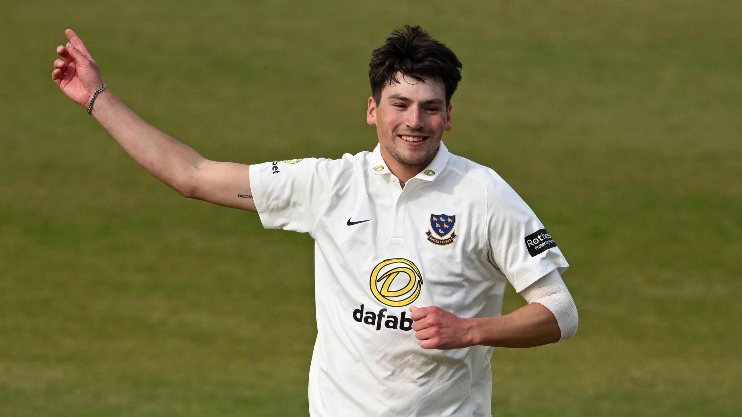 Sussex's Henry Crocombe, wearing the white Sussex jersey, celebrates taking the wicket of Yorkshire's Logan Beek in April.