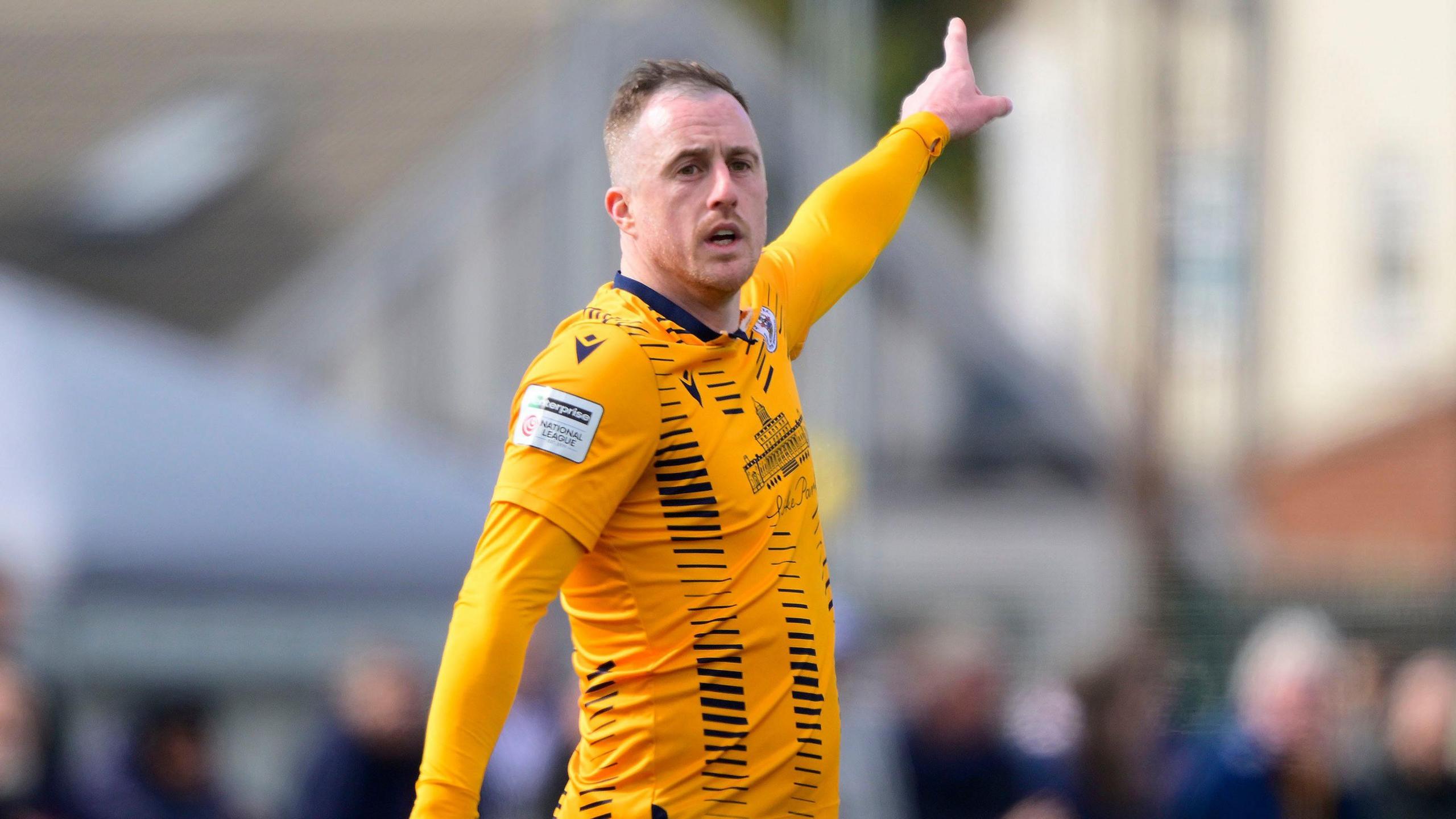 Scott Davies points in the air while playing 