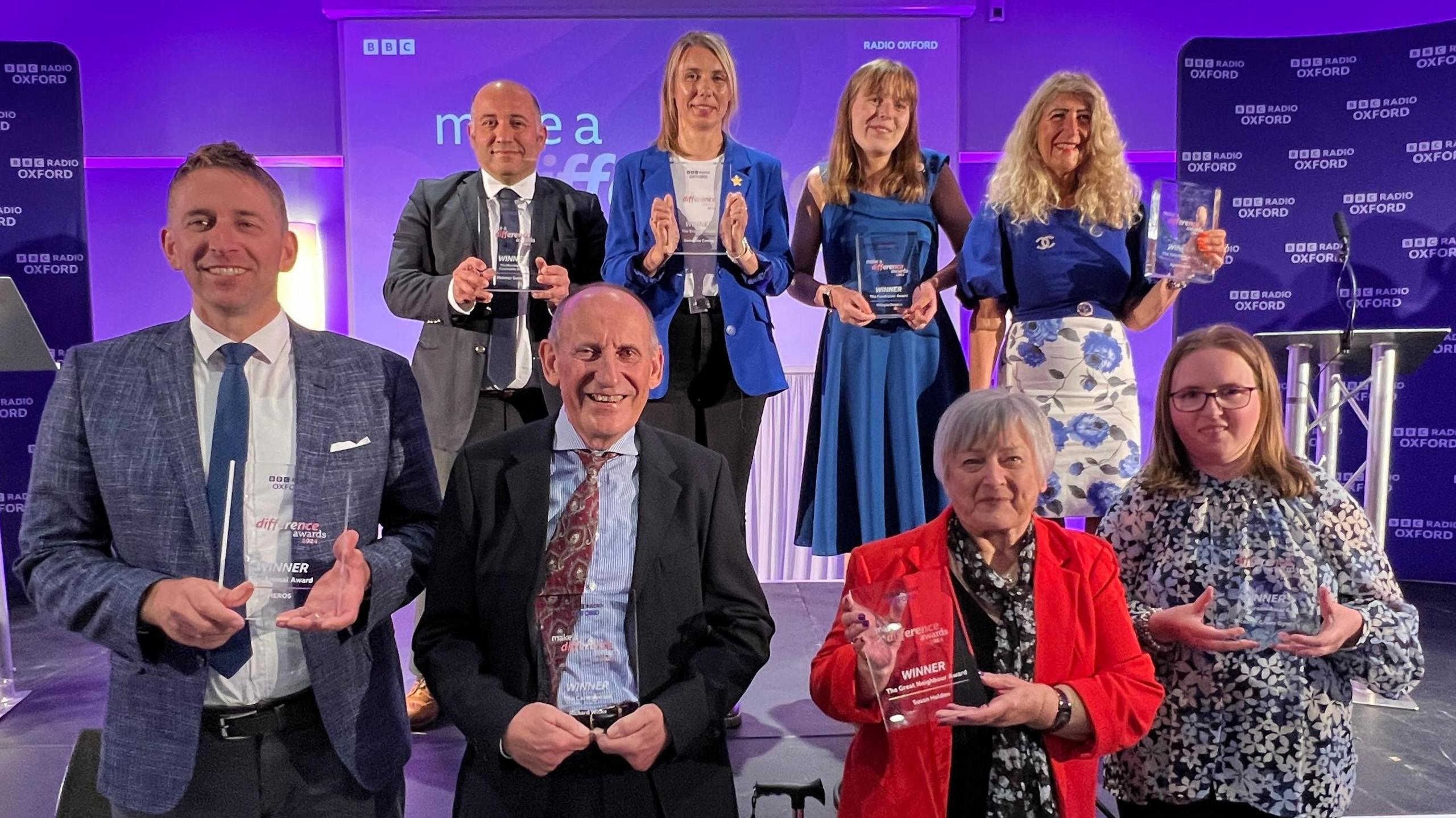 The BBC Radio Oxford Make a Difference Awards winners stood on a stage with their awards