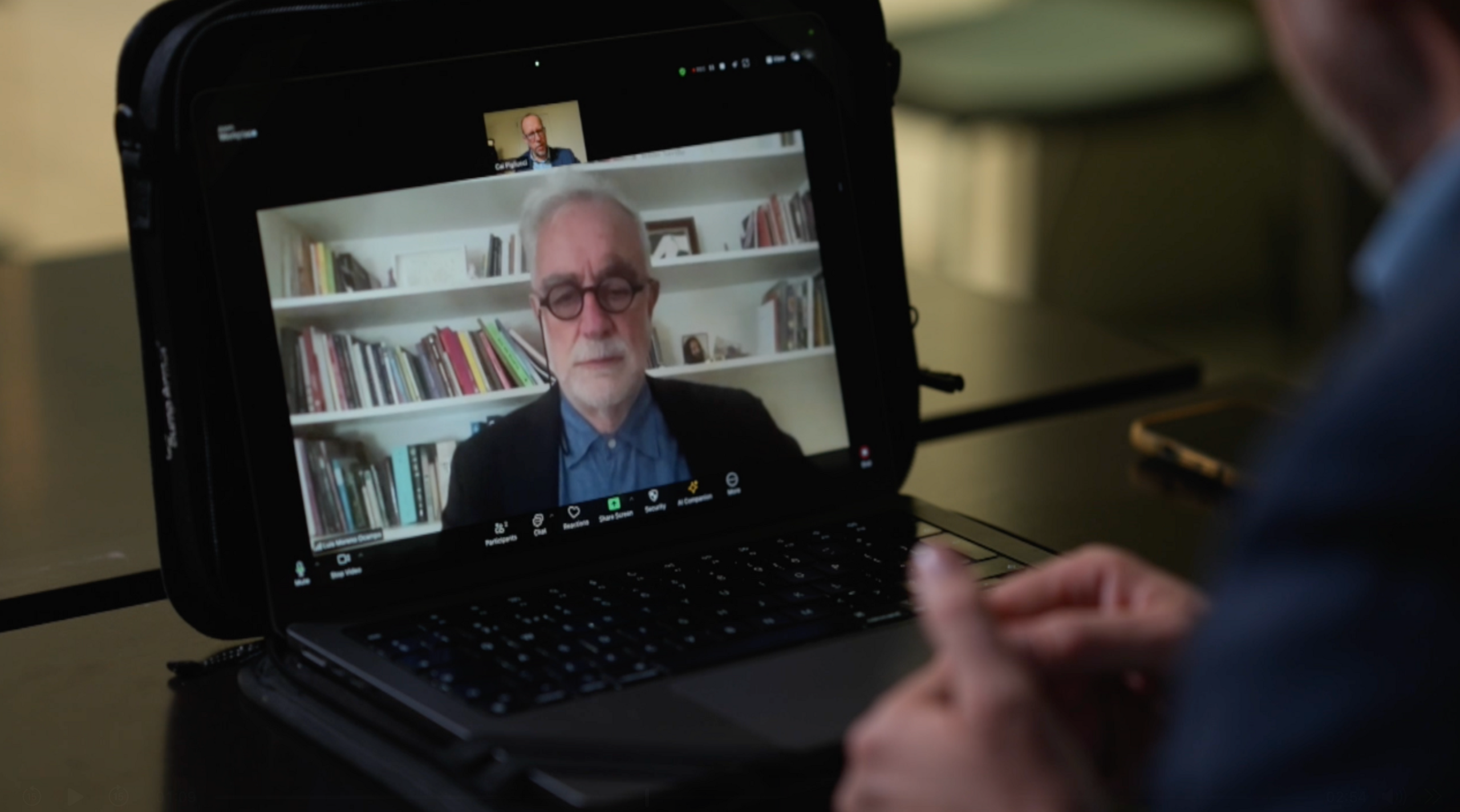 Moreno Ocampo is shown on a laptop screen talking in a video chat with a BBC reporter