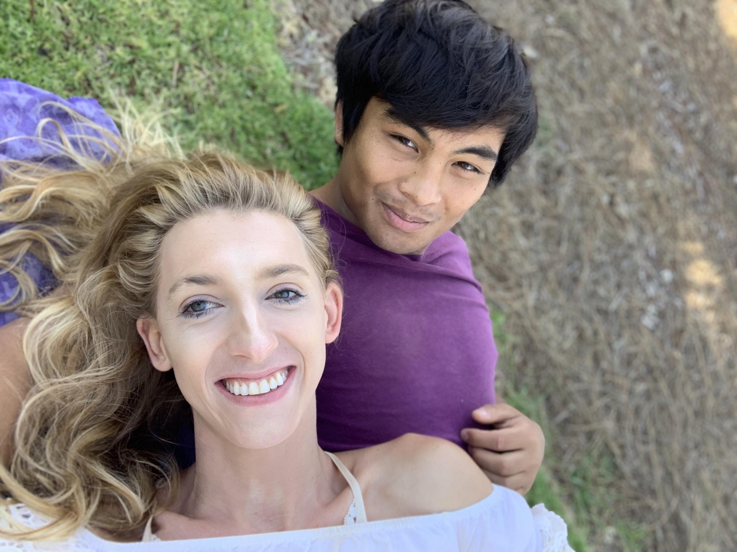 Daniella and Josh lying down outside on a blanket