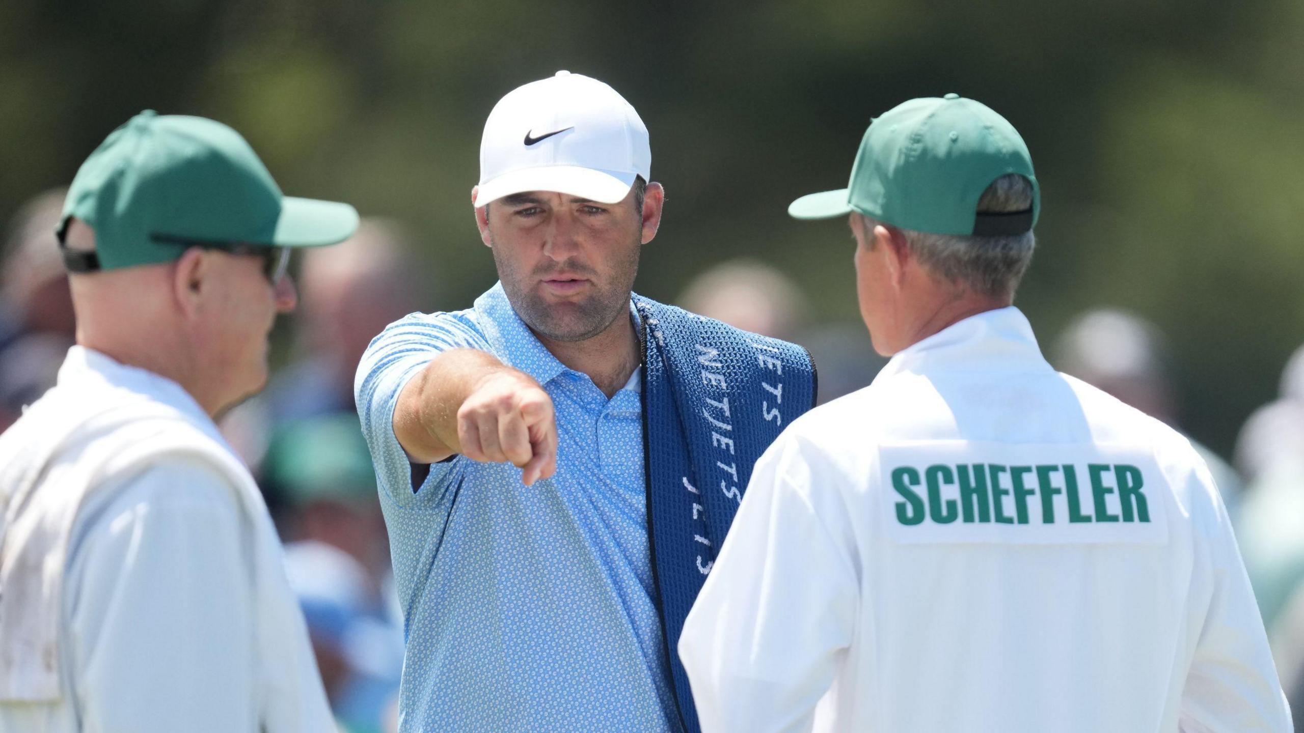 Scottie Scheffler points to his caddie during Masters 2026 practice at Augusta National