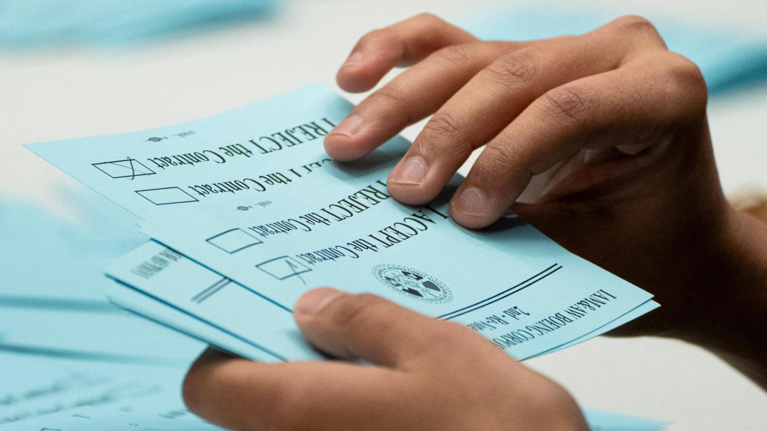 A union member from the International Association of Machinists and Aerospace Workers District 751 counts ballots after a vote on a new contract proposal from Boeing at a union hall during an ongoing strike in Seattle, Washington, US 4 November, 2024. 