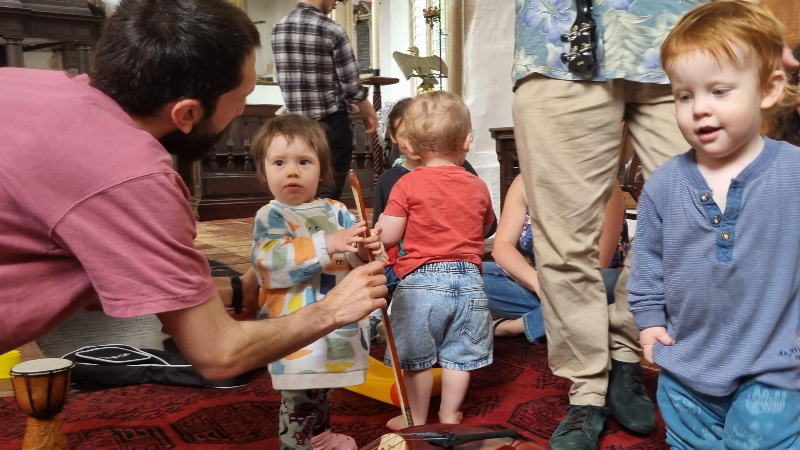 Dads and children at a fathers and family music group