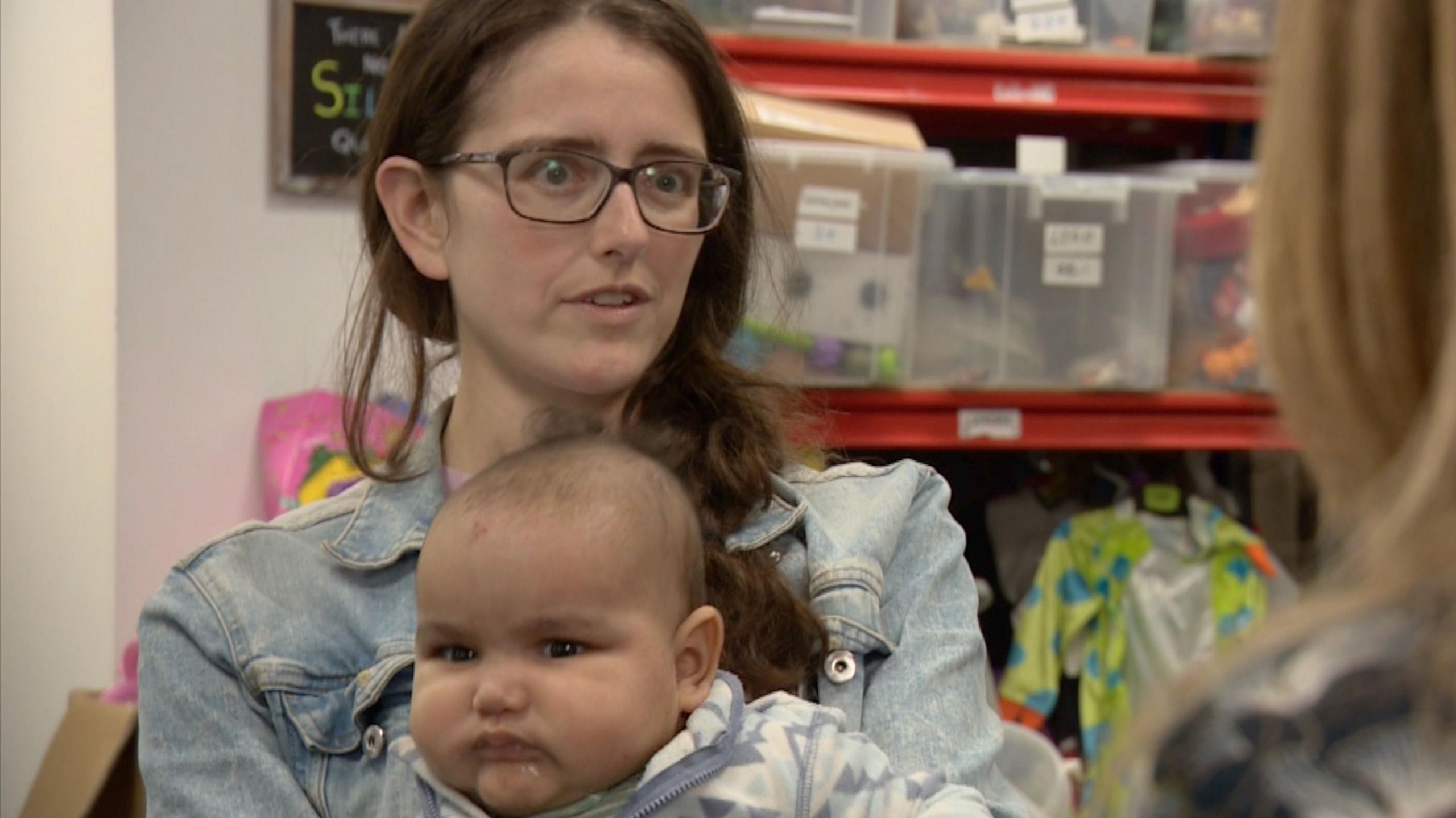 A mother with her baby on her lap