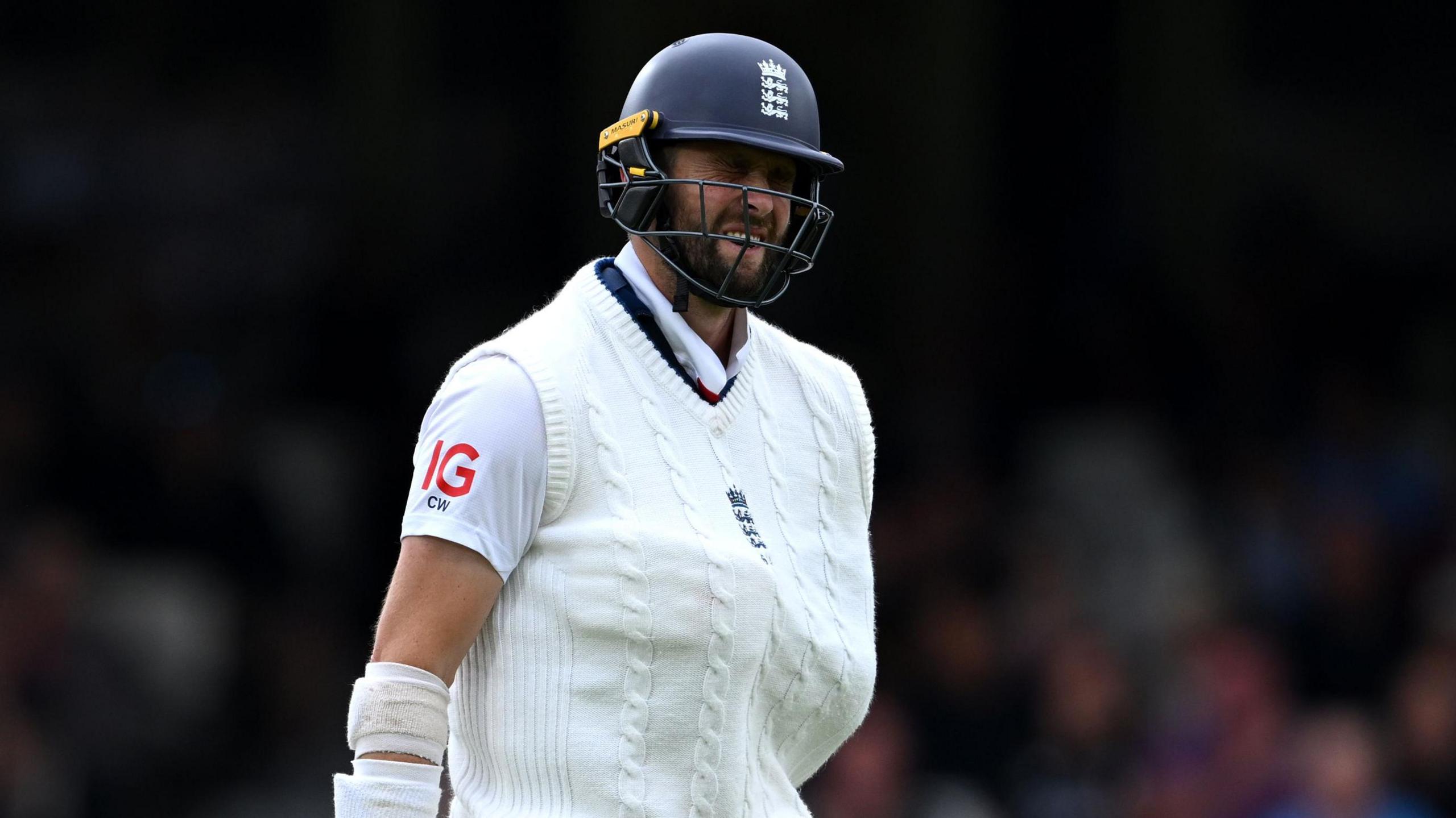 Chris Woakes with his injured shoulder inside his England jumper when he came out to bat at the Oval