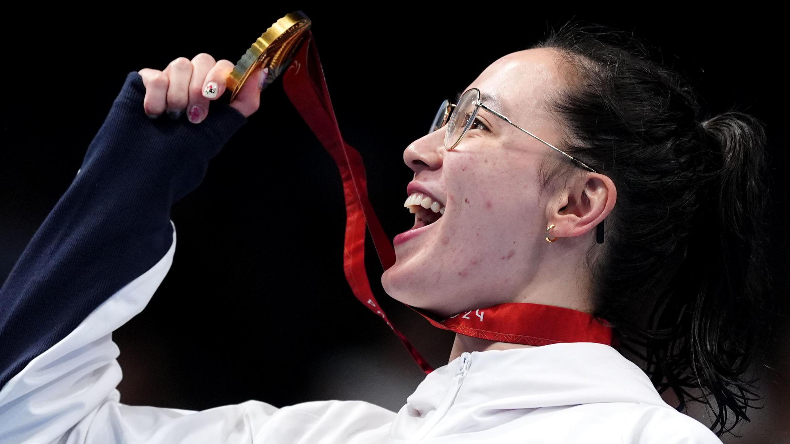 Alice Tai holds her gold medal