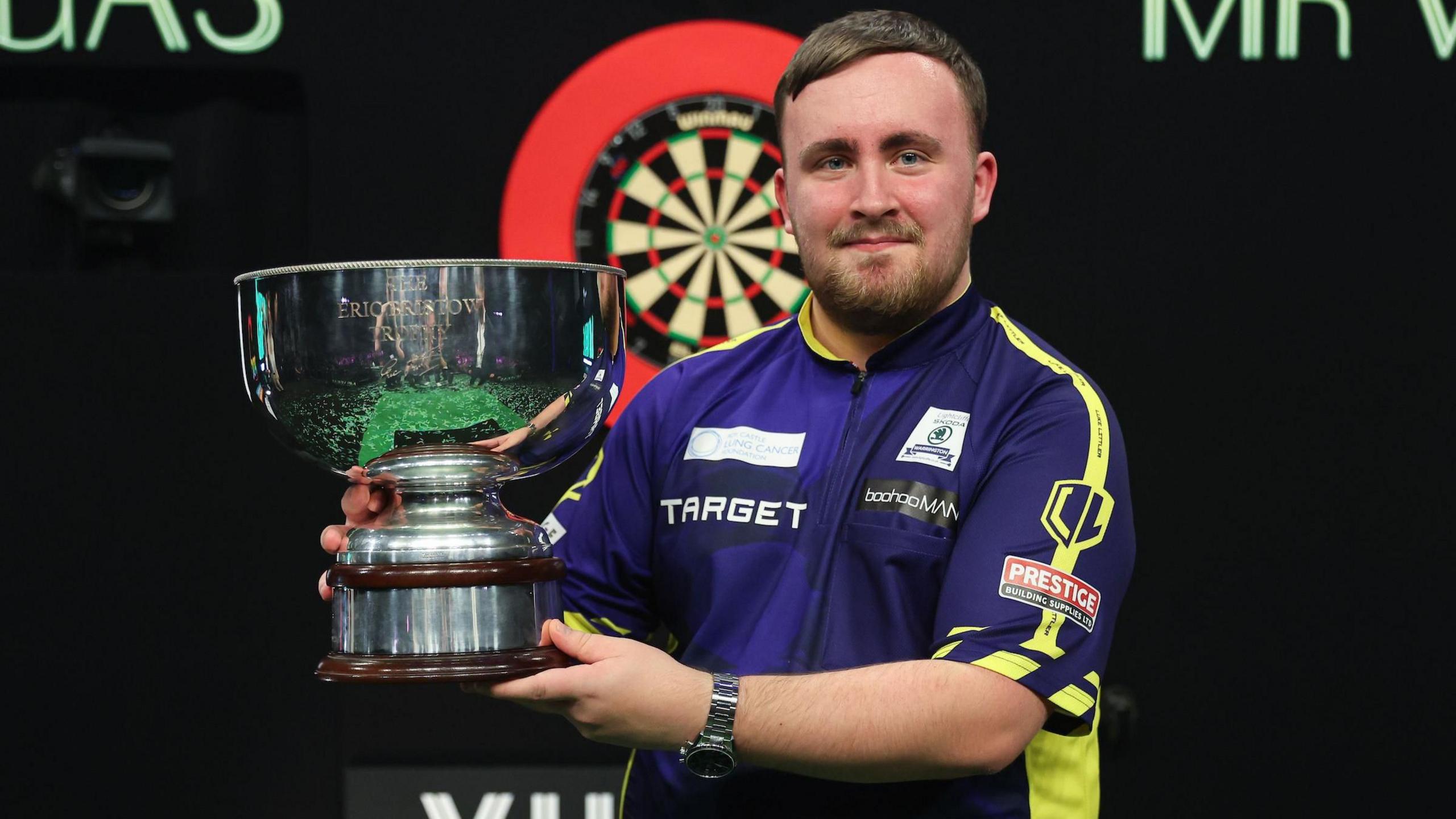 Luke Littler holds the Grand Slam of Darts trophy