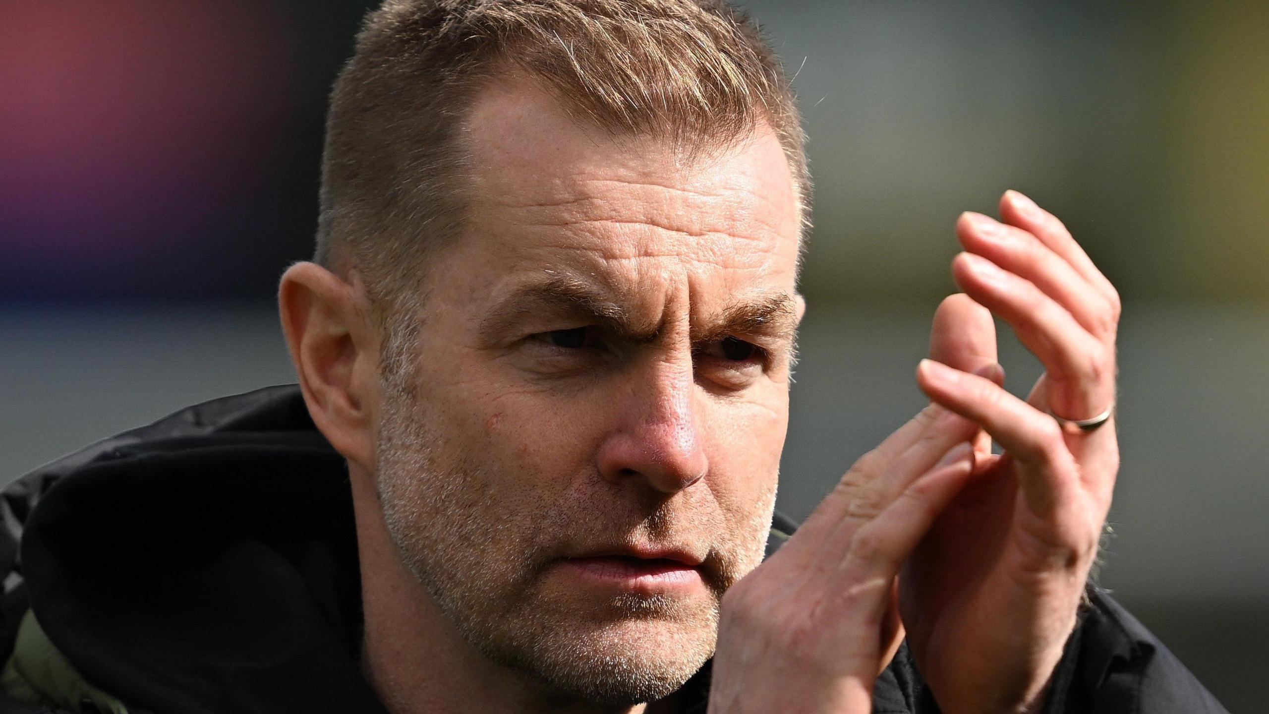 Harrogate Town manager Simon Weaver applauds the club's fans.