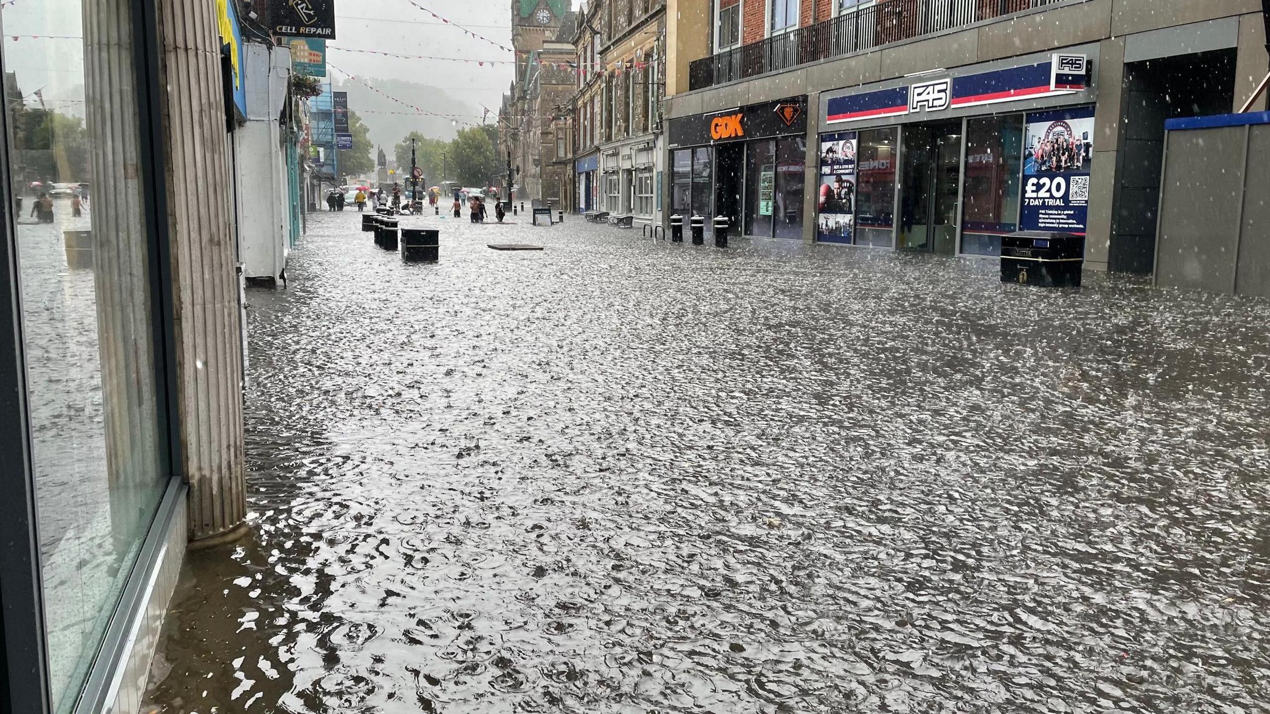 Heavy rainfall lands on an already flooded Winchester High Street 