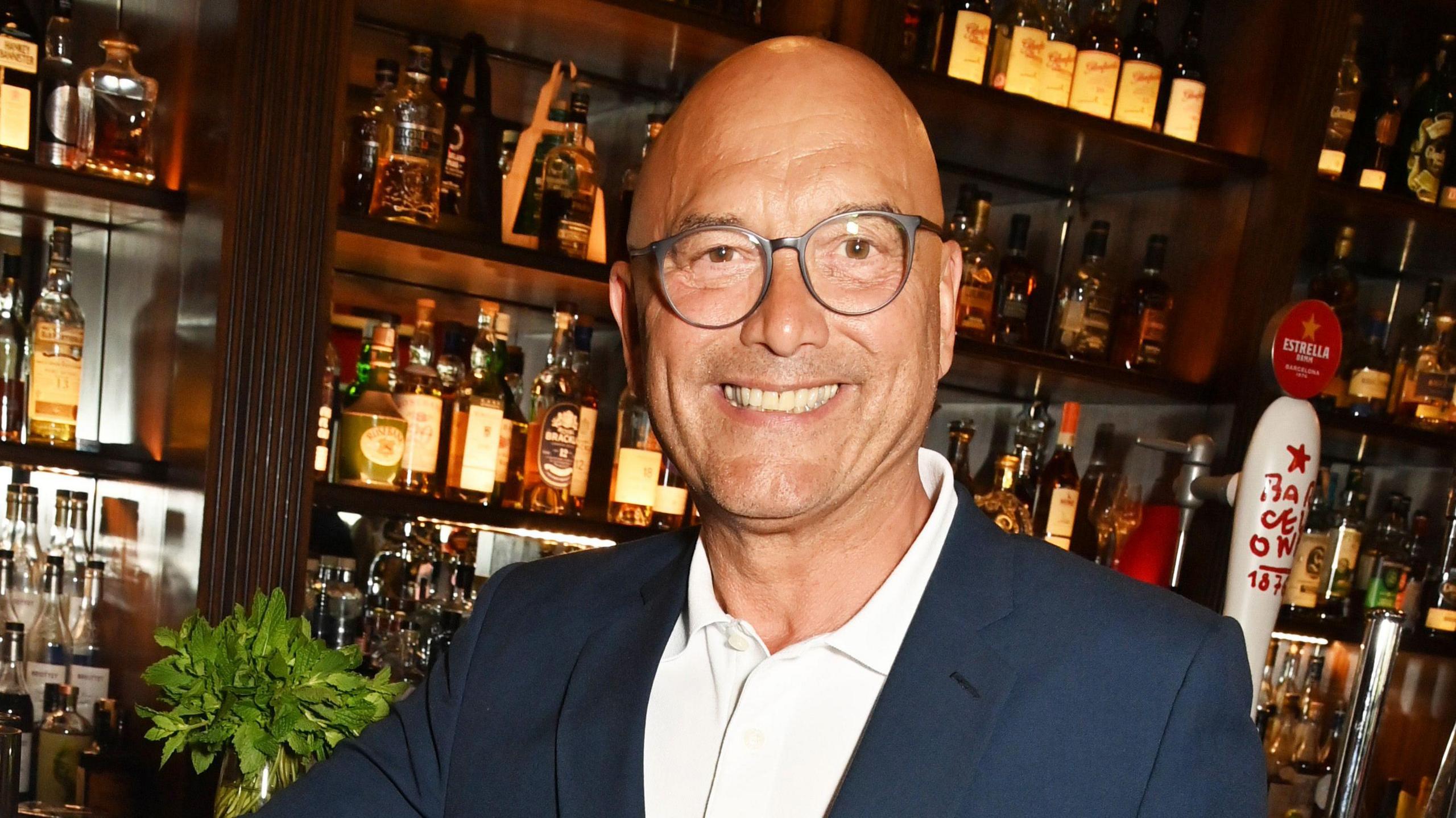 Gregg Wallace standing at a bar and smiling