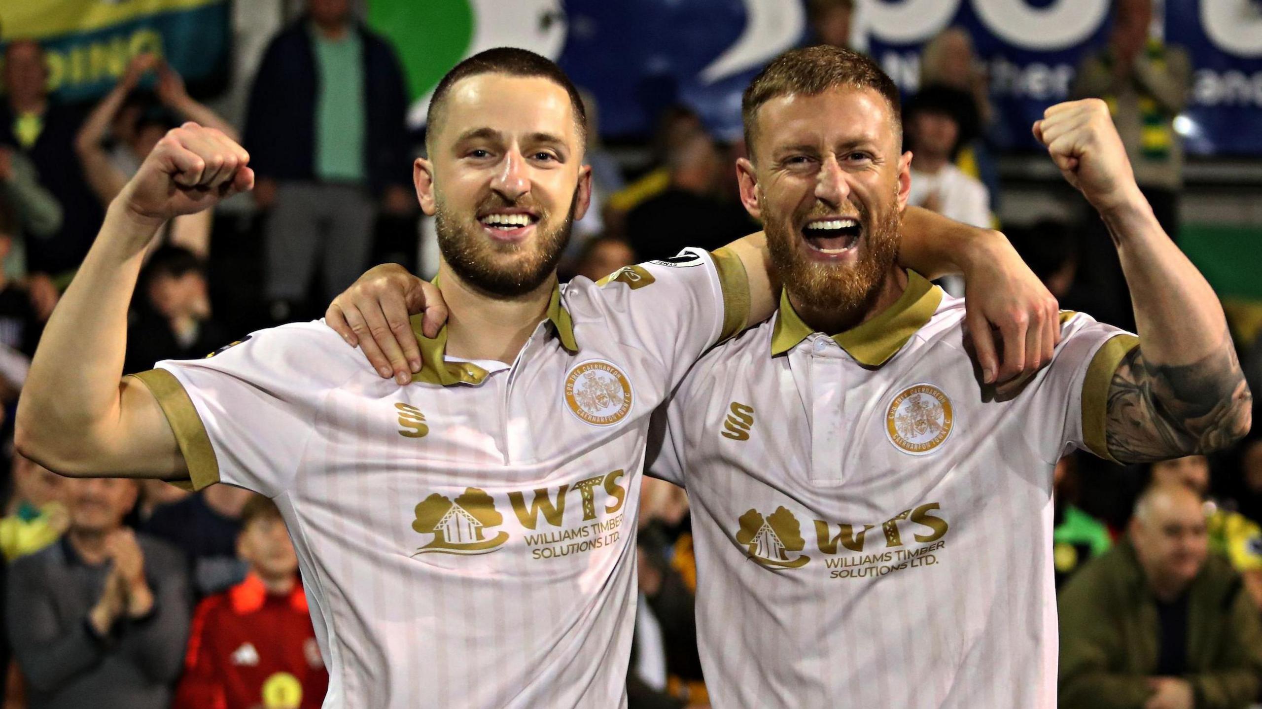 Caernarfon Town's Phil Mooney and Joe Faux celebrate their sides penalty shoot-out win over Crusaders