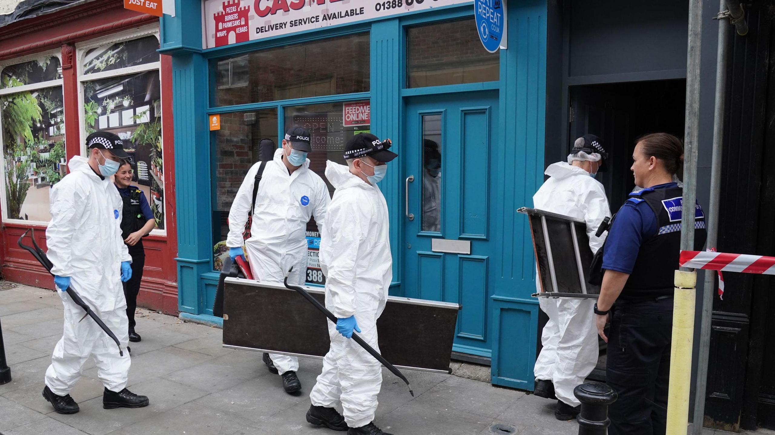 Forensic officers enter the building where the baby's body was found in Bishop Auckland