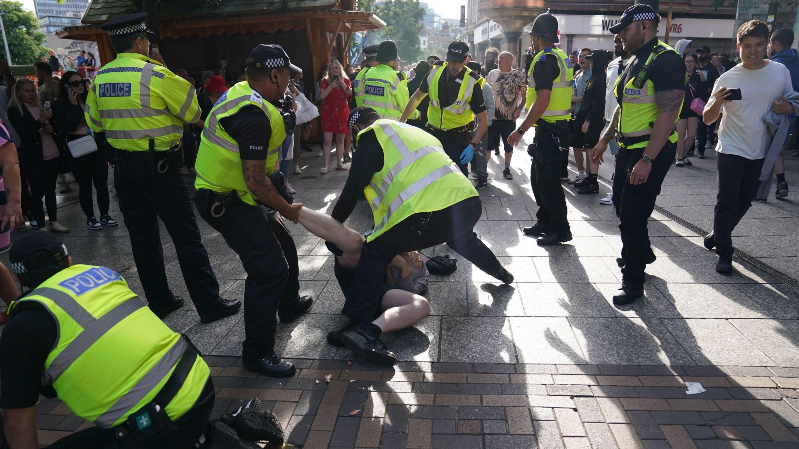 Officers reacting at the scene of the protest in Nottingham's Old Market Square