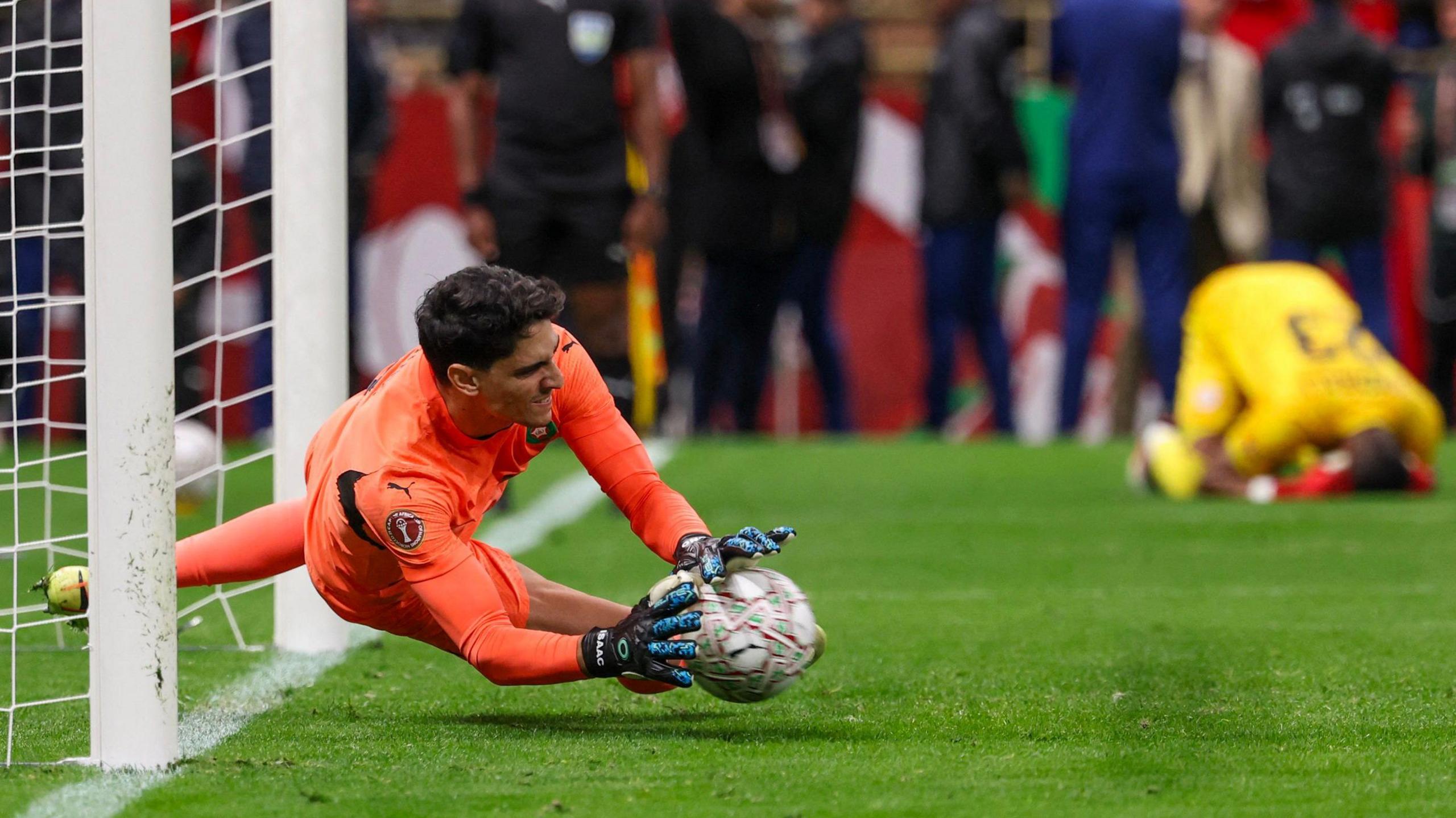 Morocco goalkeeper Yassine Bounou saves a penalty
