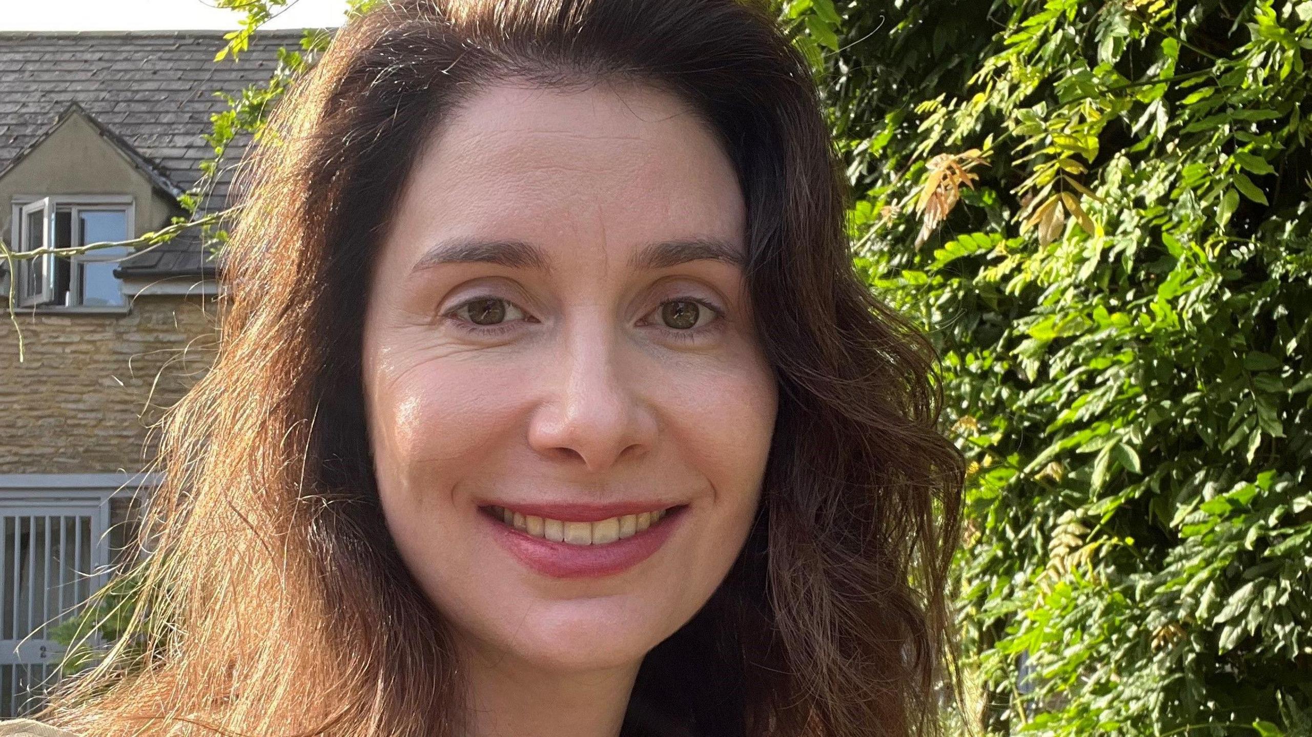 Laura Horwill, stood outside, smiling at the camera