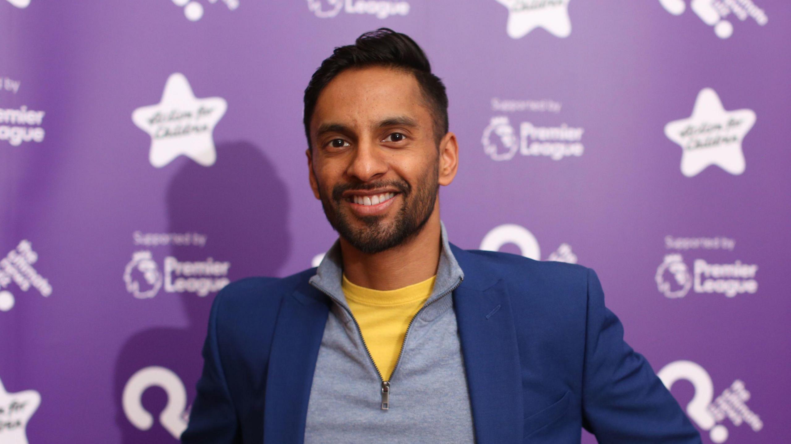 Teacher and presenter Bobby Seagull smiling at a press event