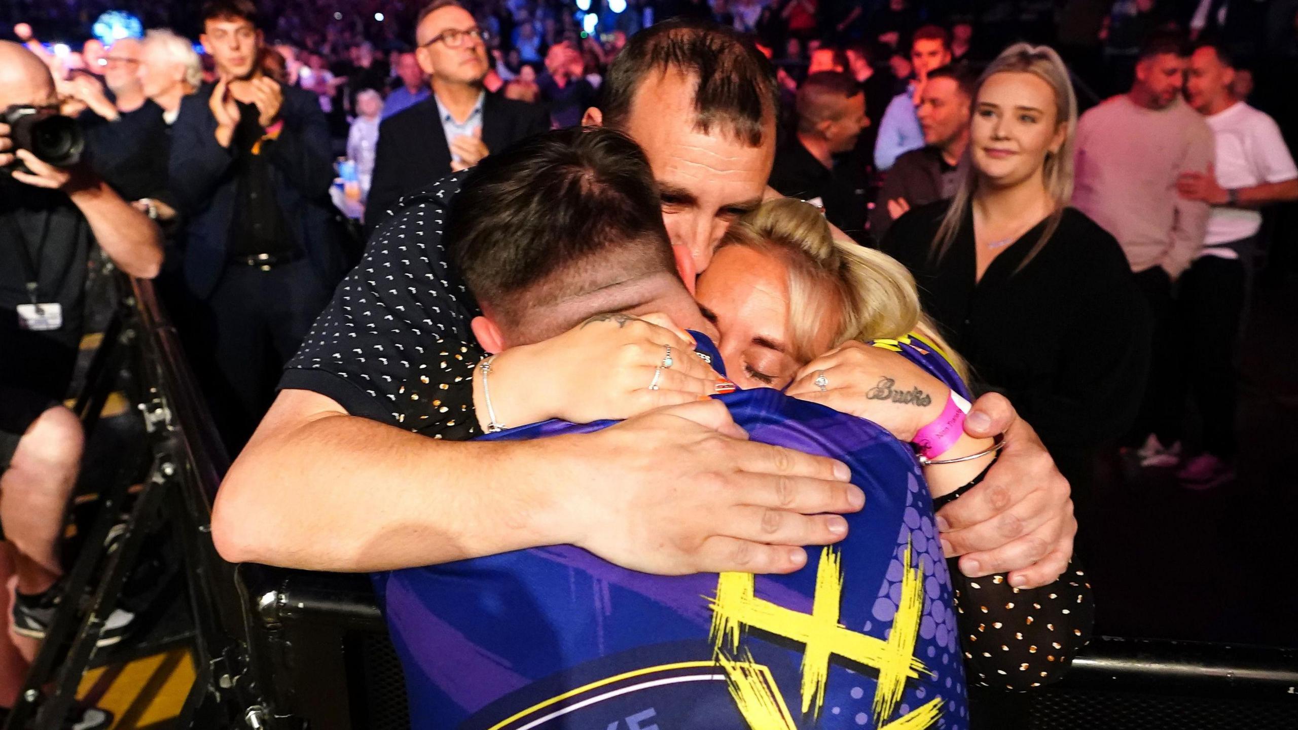 Luke Littler celebrates with his parents after winning the 2024 Premier League Darts