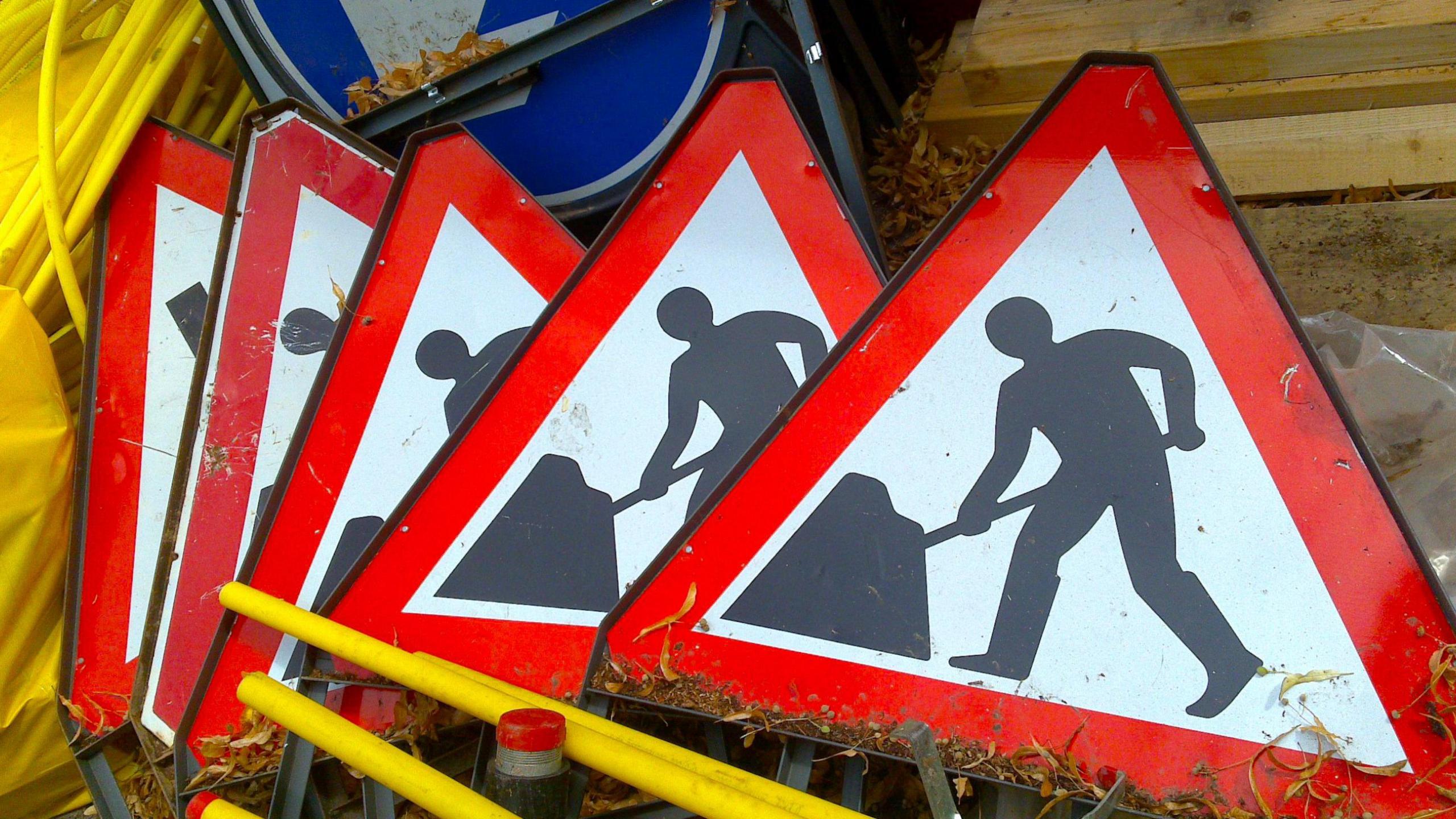 Image of five roadworks signs in a pile