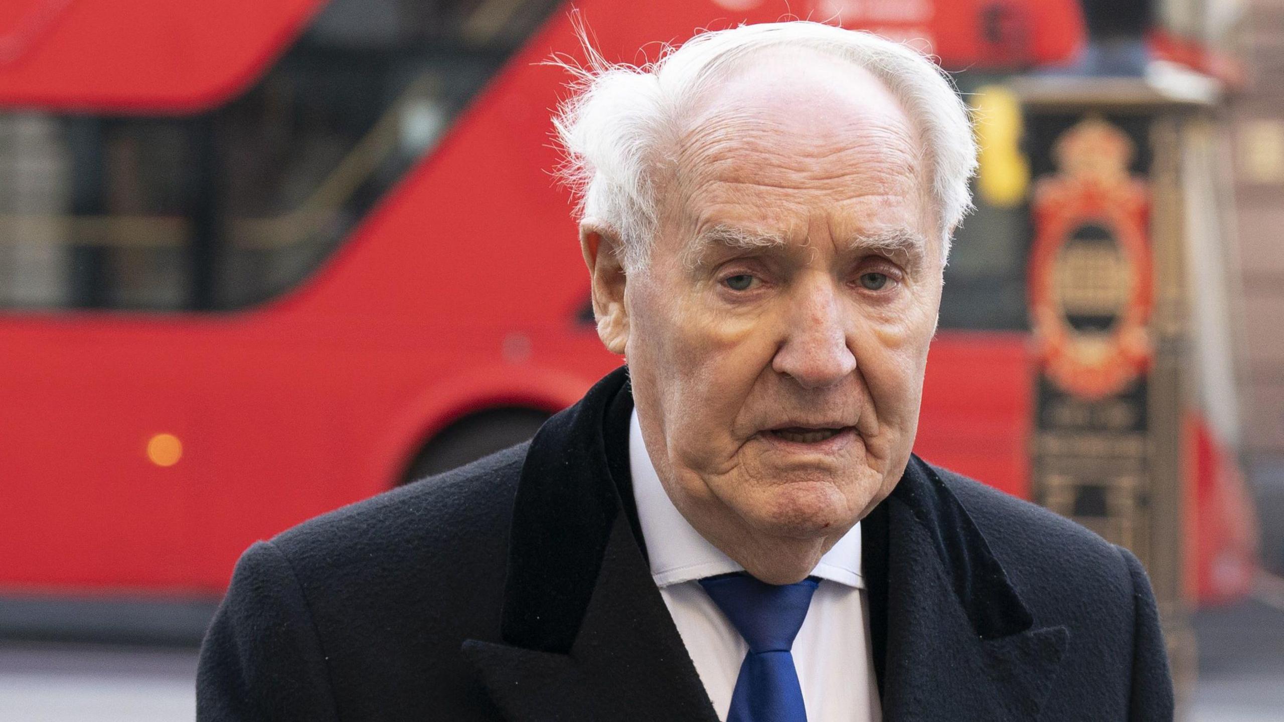 Sir Frederick Barclay. An old white man in a shirt and tie walks with purpose in central London.