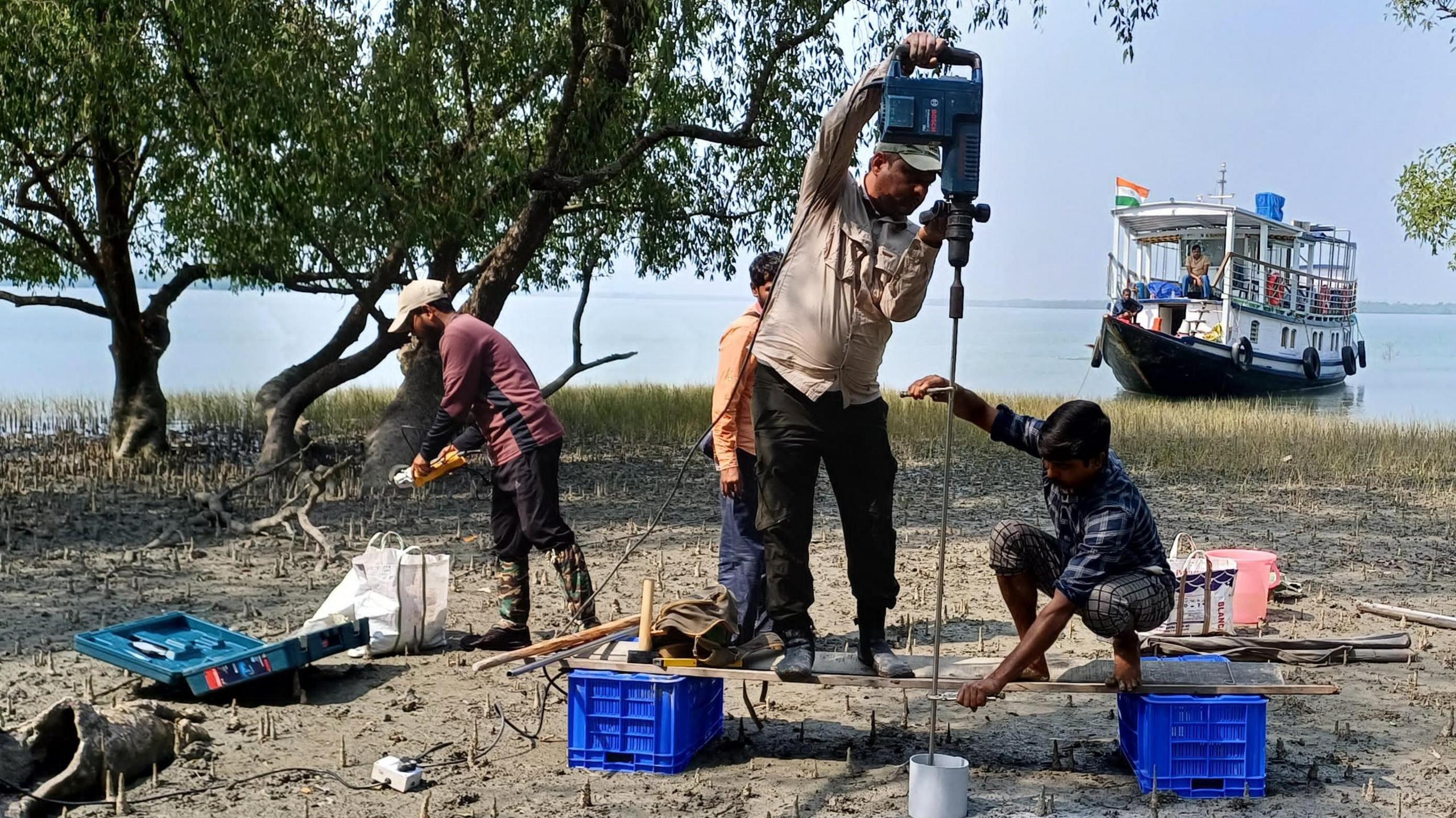 Researchers drilling a hole in the ground